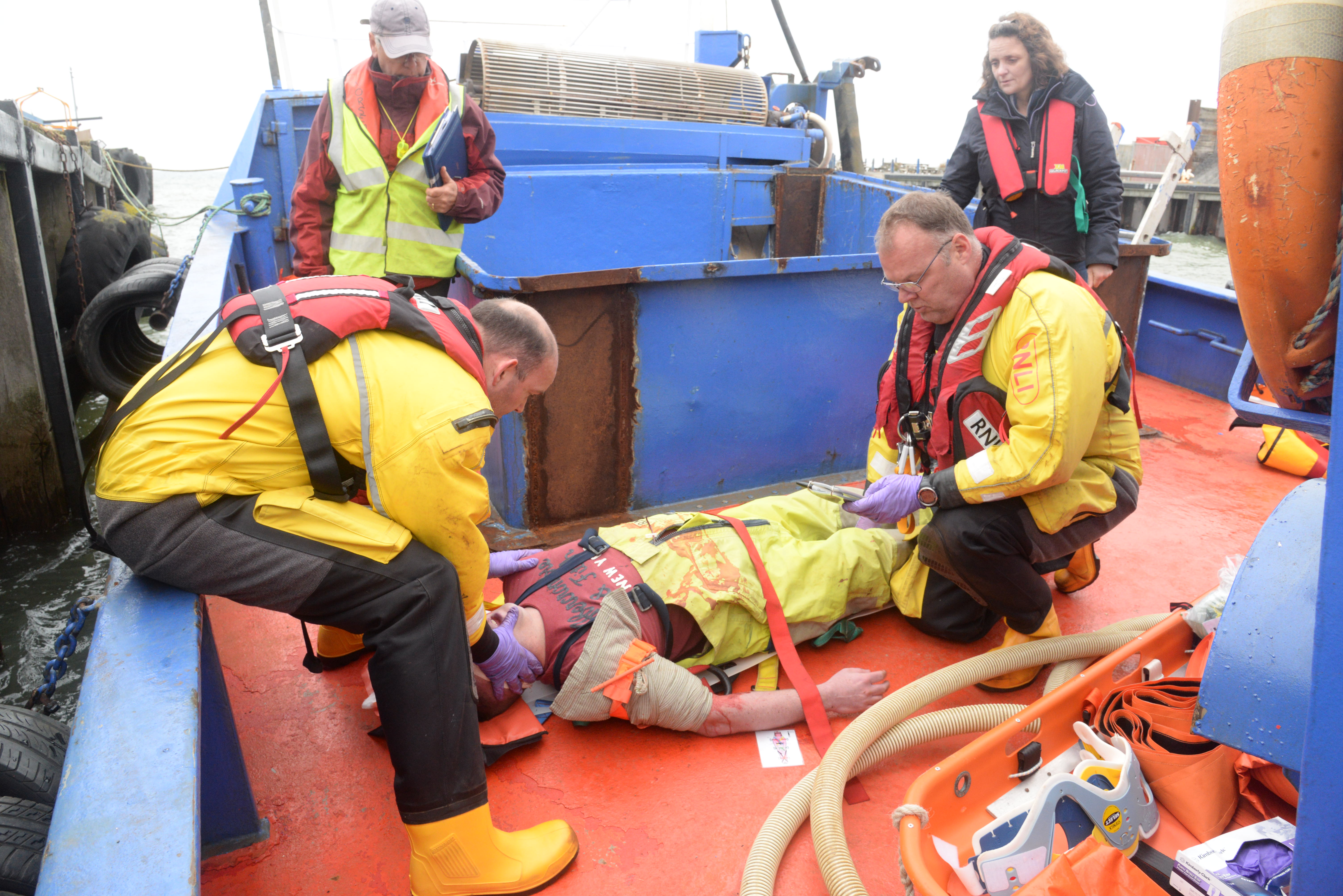 Crewmembers Andy Williams and Tim Smith watched by Dr Terry Stefani manage to extract casualty Ian Wood from the confined area around the hold of the 'Oly Ray'during the 2018 Whitstable Lifeboat 'Dan Davies' seamanship and first aid exercise on Saturday. Picture: Chris Davey/RNLI Whitstable.