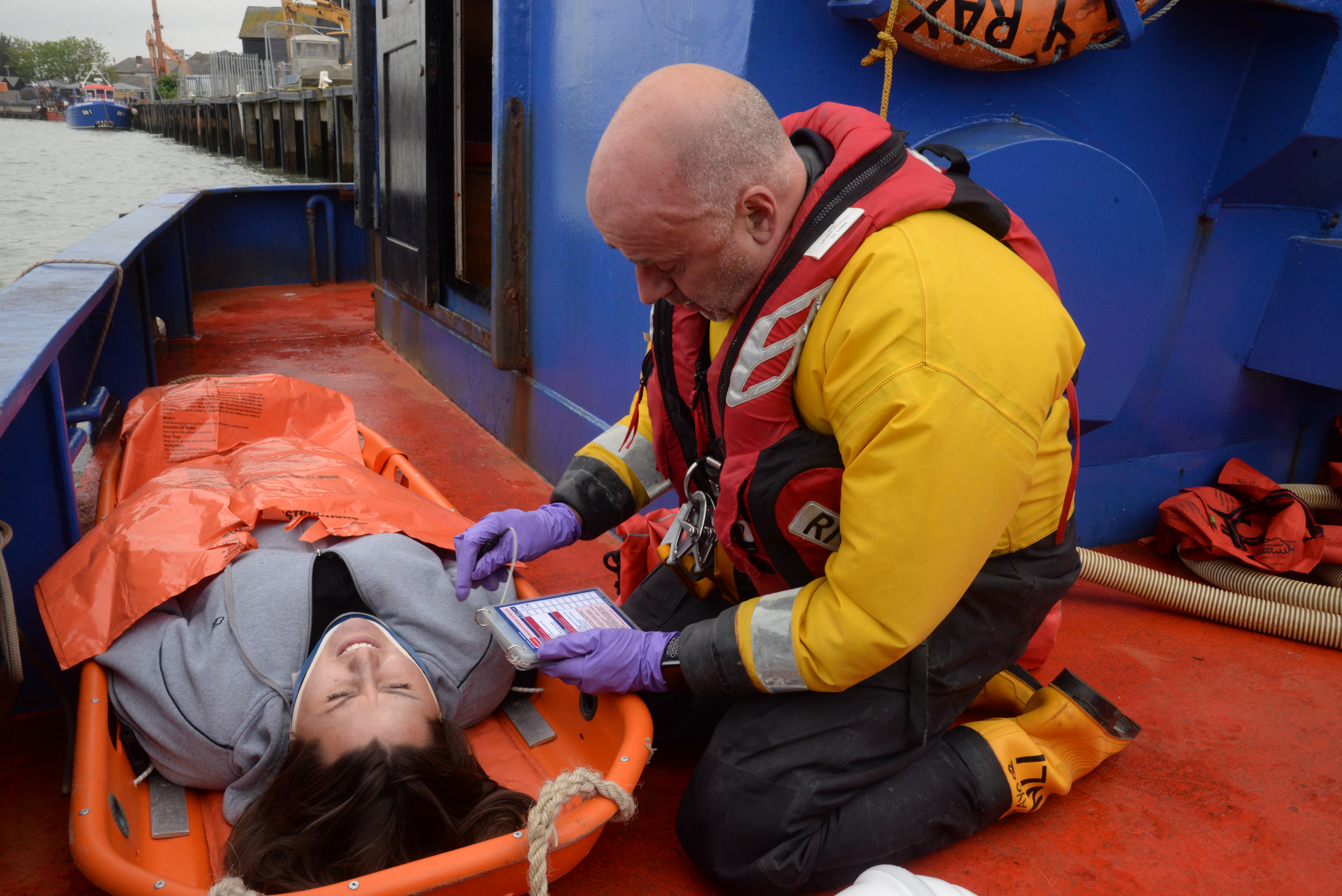 Helmsman Andy Mayo prepares casualty Sian Sidders for transfer to the lifeboat after she was extracted from the confines of a lower bunk in the cramped wheelhouse during the 2018 Whitstable Lifeboat 'Dan Davies' seamanship and first aid exercise on Saturday. Picture: Chris Davey/RNLI Whitstable.