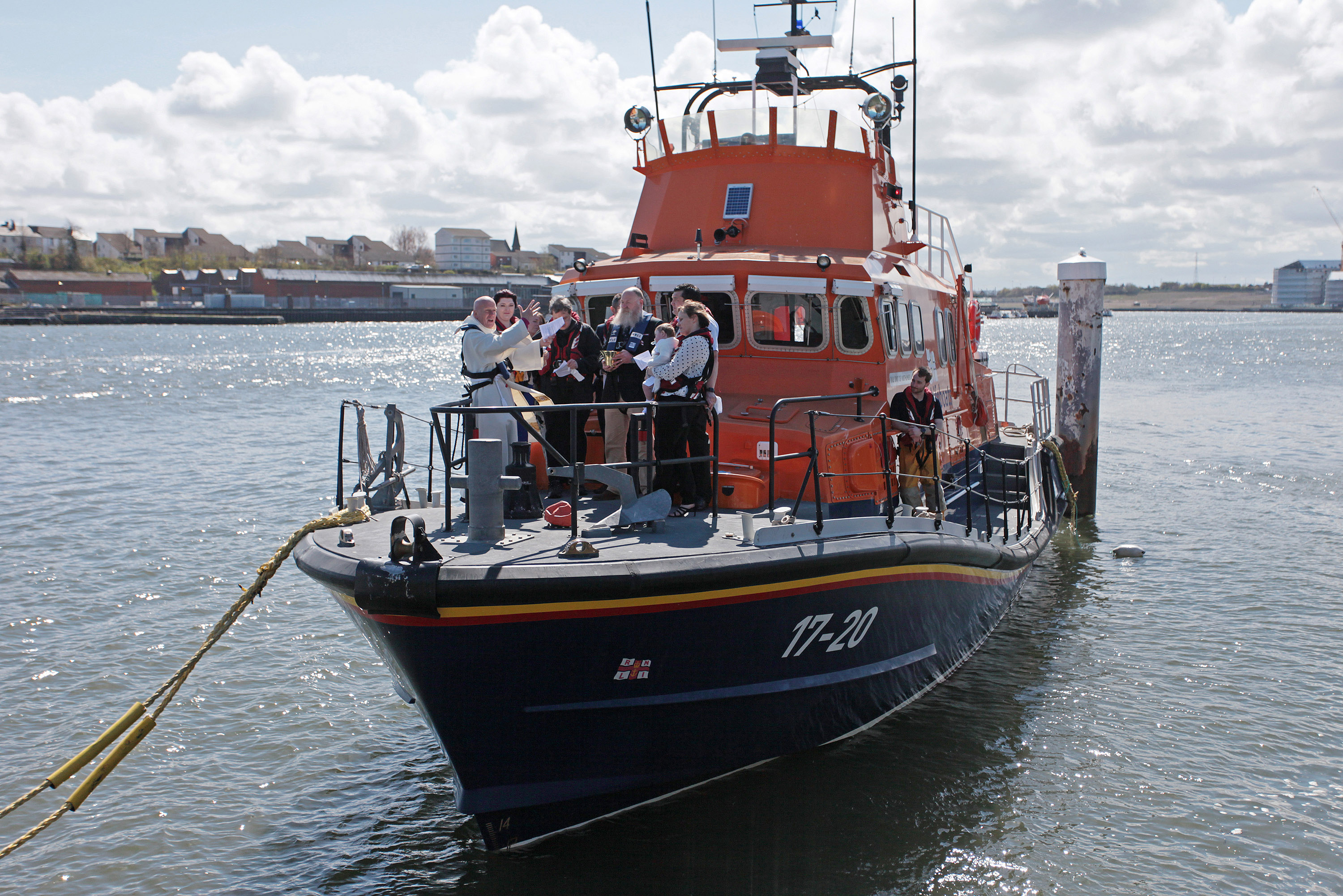 29 April 2018 RNLI Lifeboat christening - Harry Thomas Michael Brown is christened on board Tynemouth RNLI station's Severn class all weather lifeboat Spirit of Northumberland by Revd Canon Glyn Evans in front of proud parents Laura and Michael, the Godparents, family and friends, and Michael's fellow RNLI lifeboat crewmembers. Please credit Adrian Don/RNLI