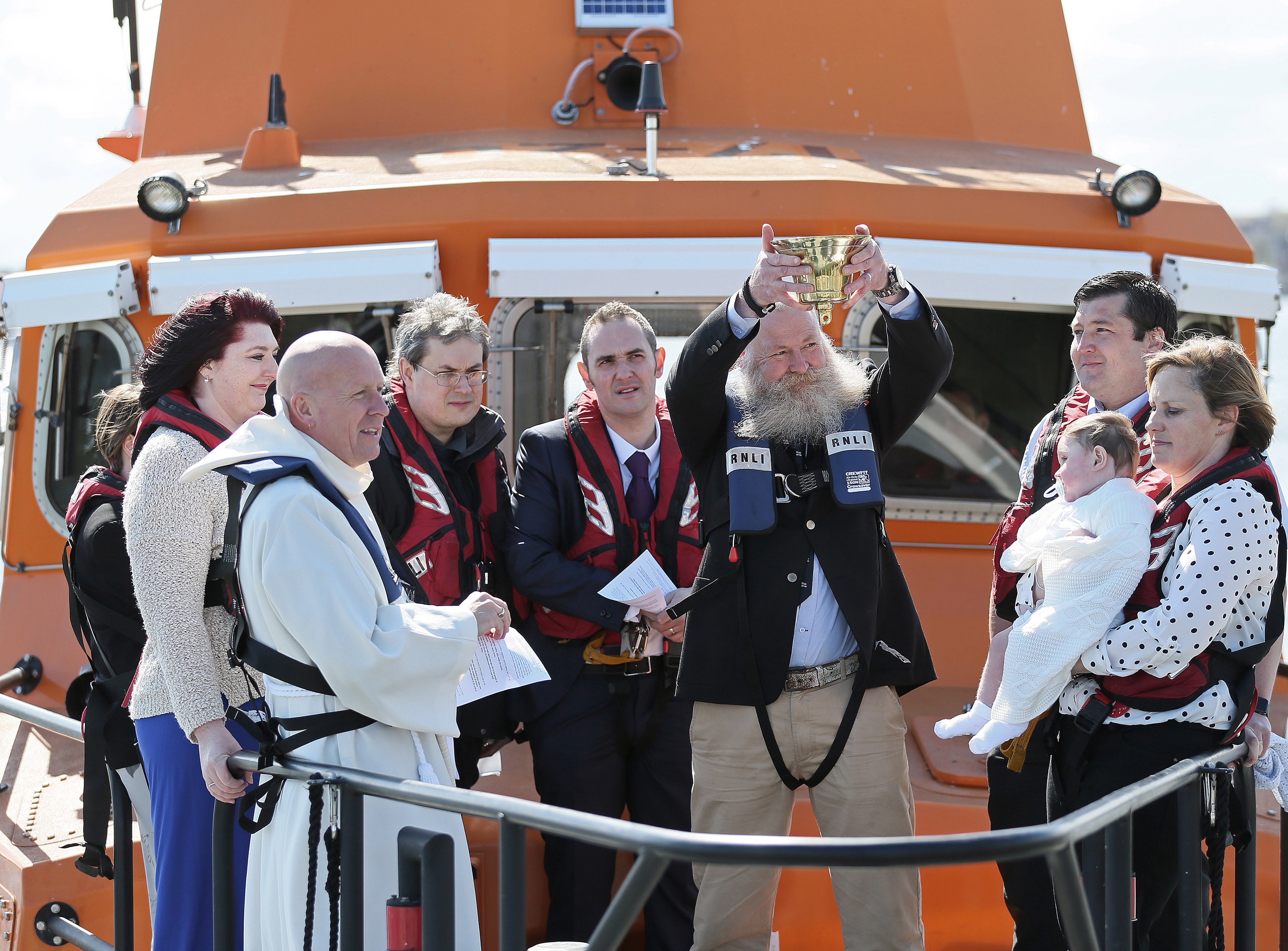 29 April 2018 RNLI Lifeboat christening - Harry Thomas Michael Brown is christened on board Tynemouth RNLI station's Severn class all weather lifeboat Spirit of Northumberland by Revd Canon Glyn Evans in front of proud parents Laura and Michael, the Godparents, family and friends, and Michael's fellow RNLI lifeboat crewmembers. Please credit Adrian Don/RNLI