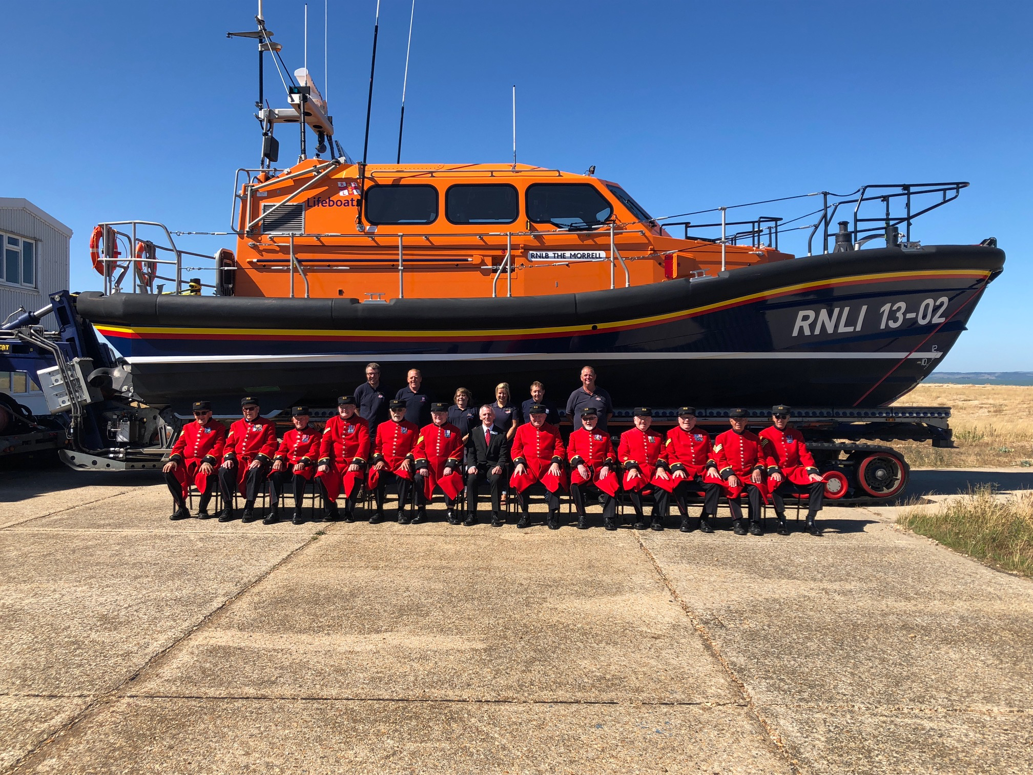 Dungeness station volunteers with the Chelsea pensioners in front the Dungeness Shannon class lifeboat 13-02 'The Morrell'
