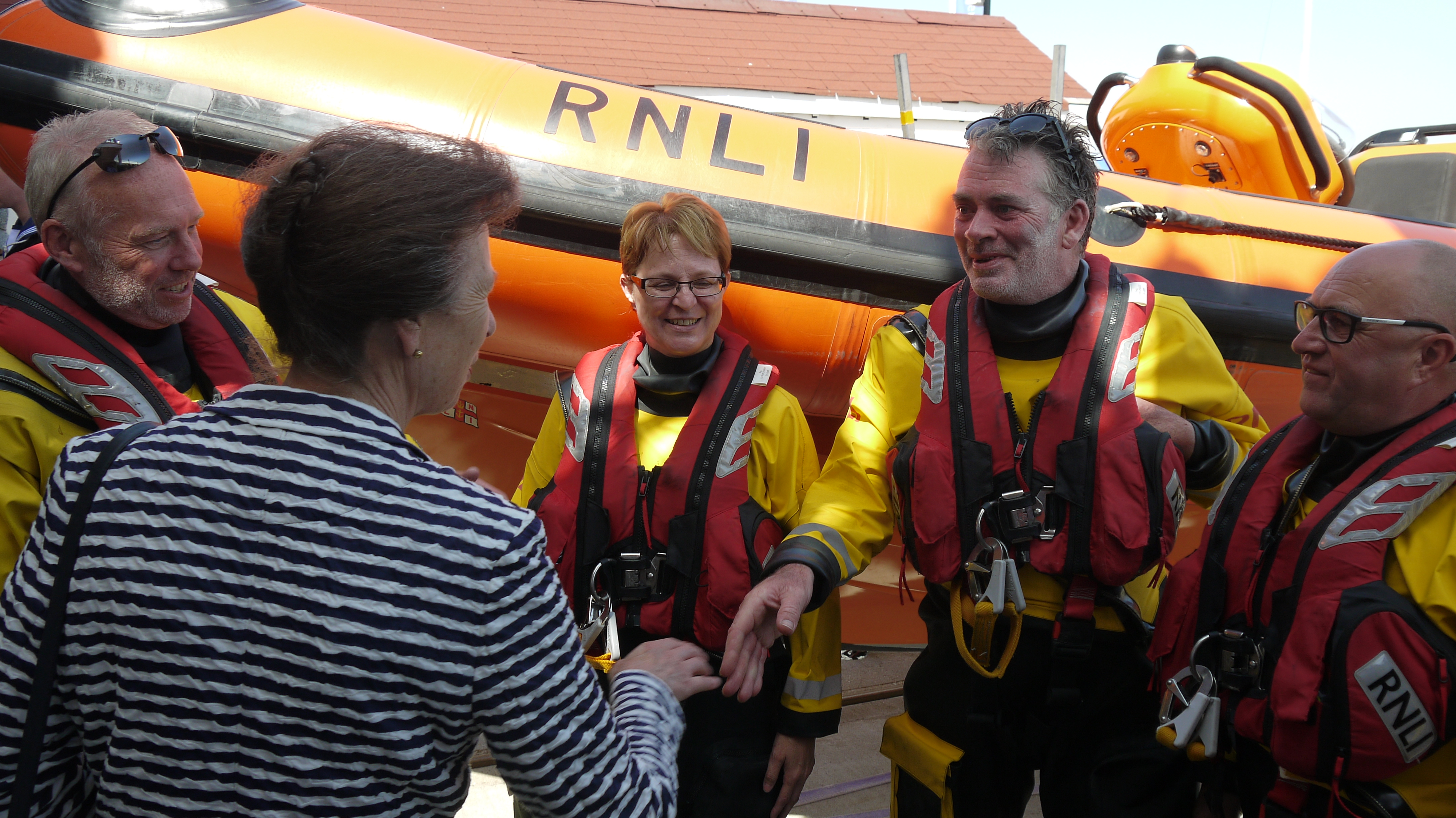 Princess shakes the hand of crew member Chris Adams.