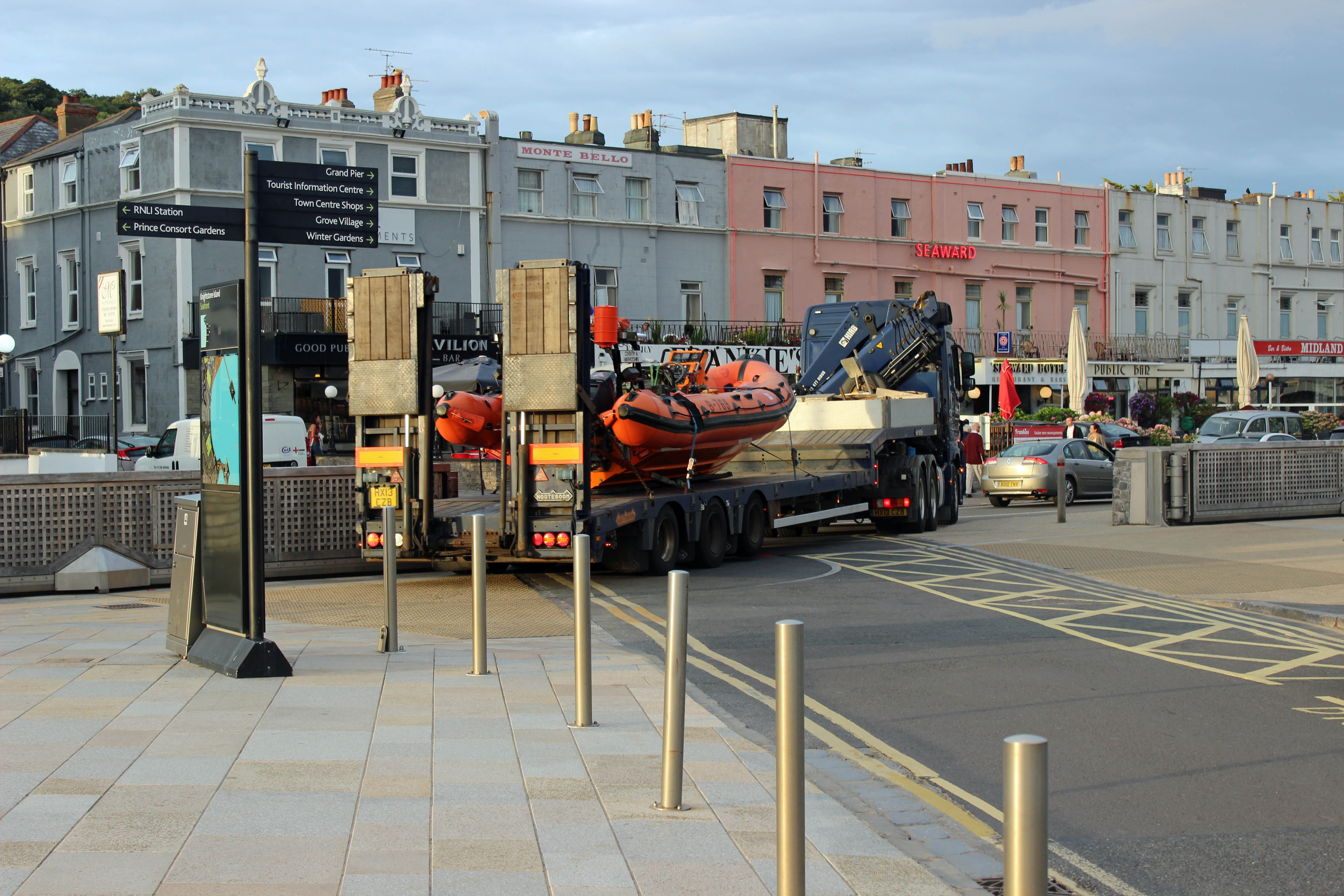 On the back of a lorry the lifeboat departs weston RNLI station.