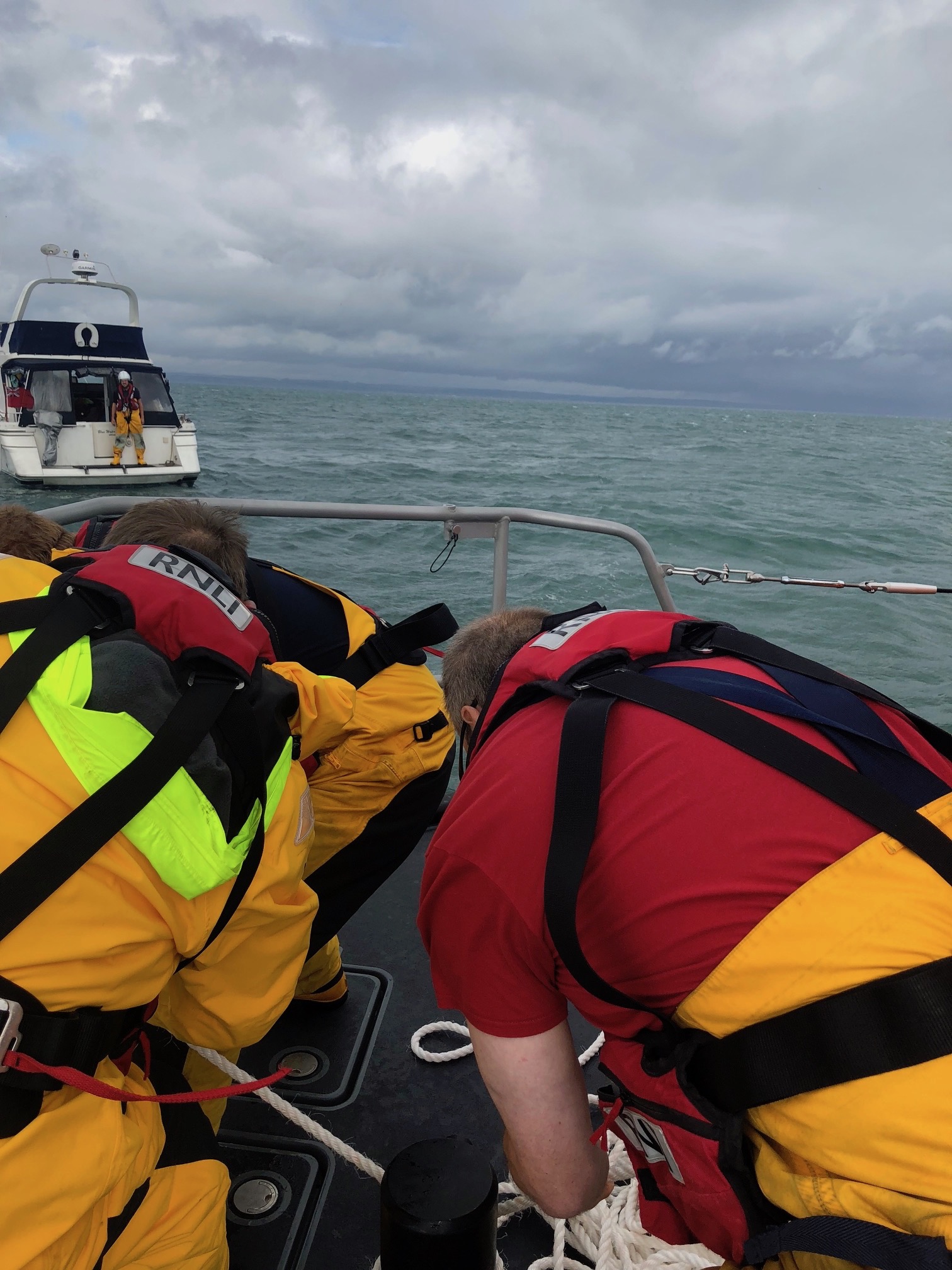 RNLI volunteer crew recovering casualty's ancho