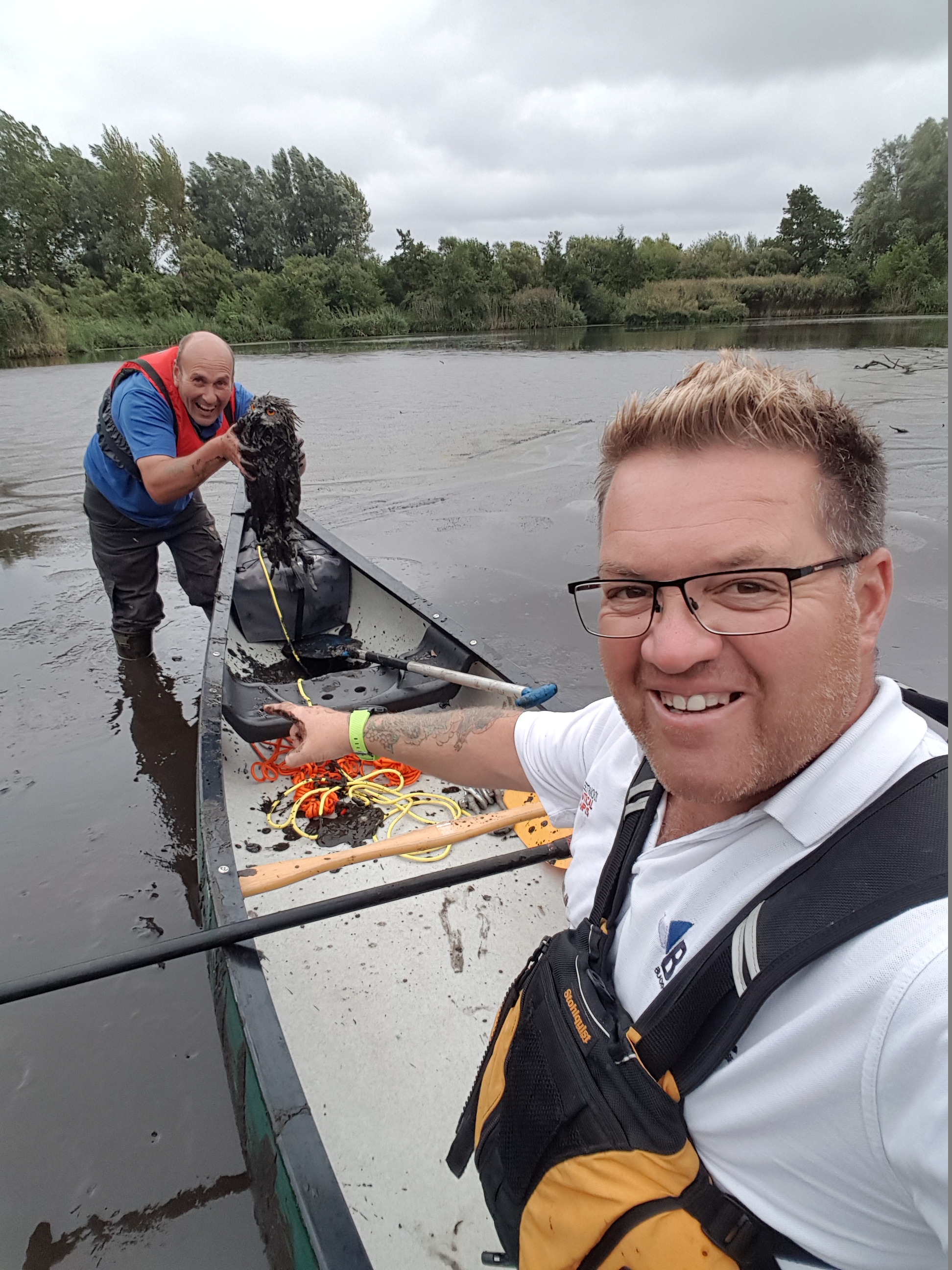 The muddied Eagle Owl safely on the canoe, with RNLI volunteers Skip Frith and Nathan Hackney
