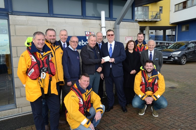 Eastbourne RNLI crew receiving a donation from the Royal Connaught Masonic Lodge