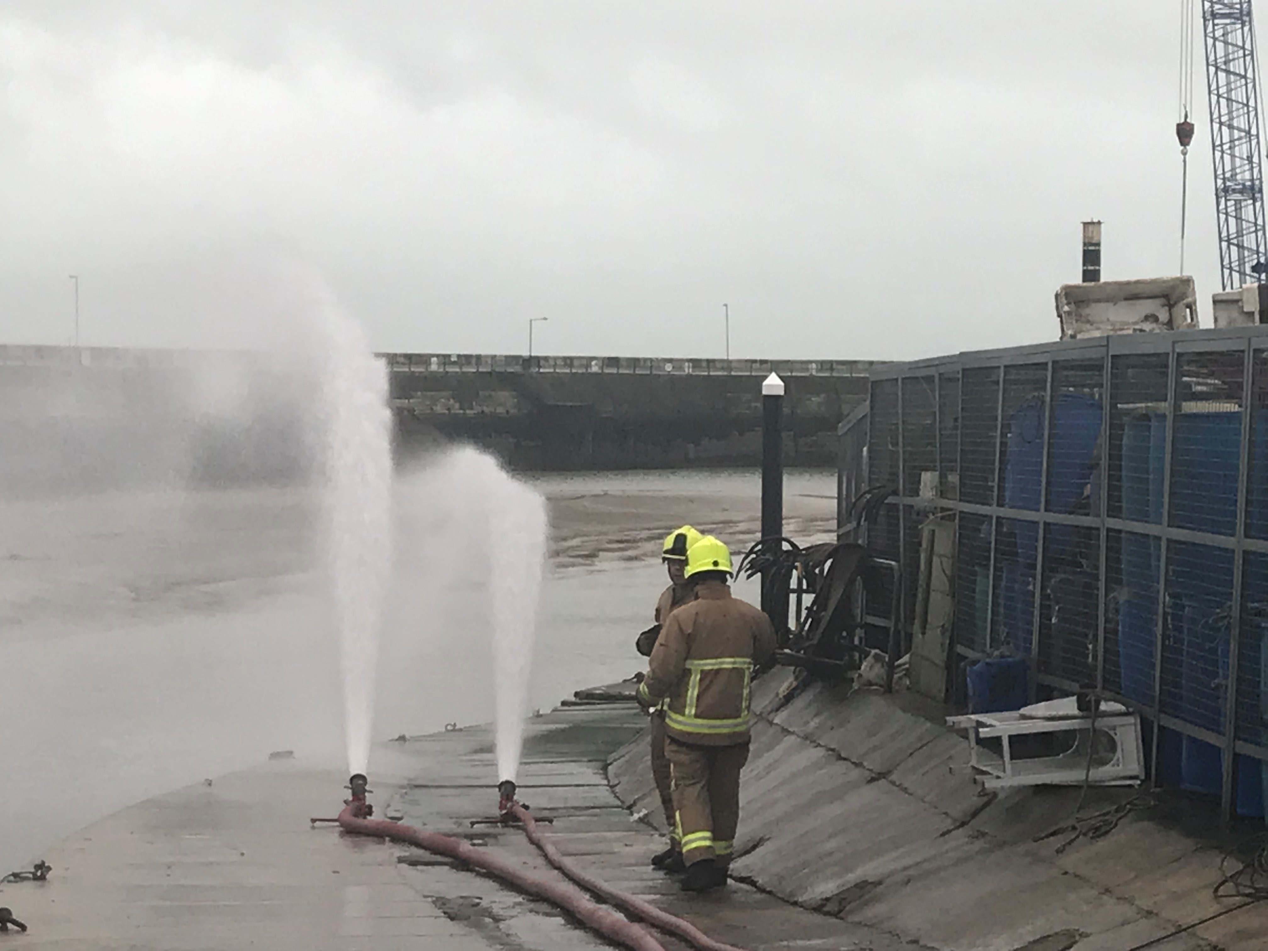 The plume of water being pumped from the sinking tug. 