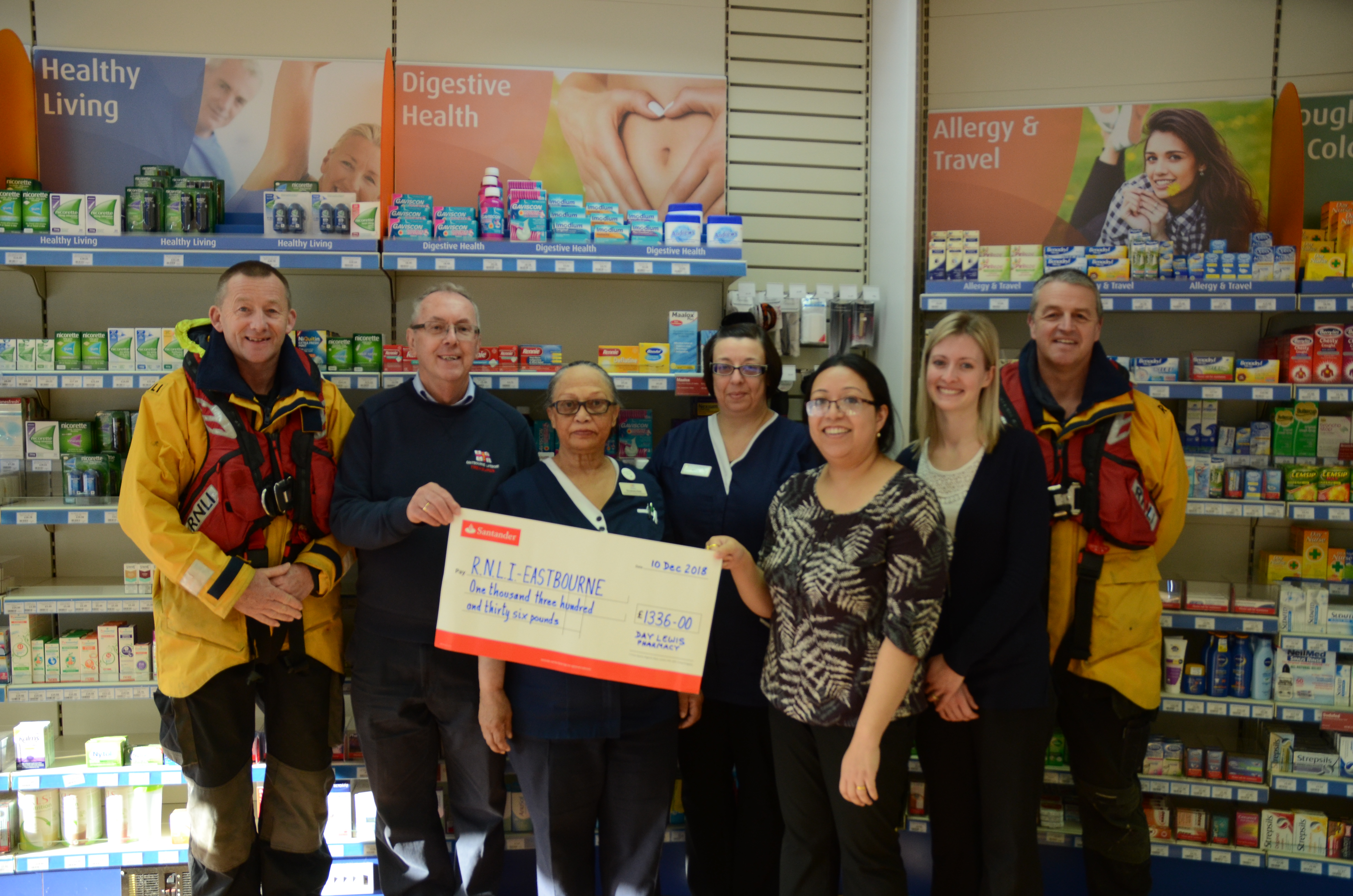 Pharmacy staff present cheque to Eastbourne lifeboat Treasurer