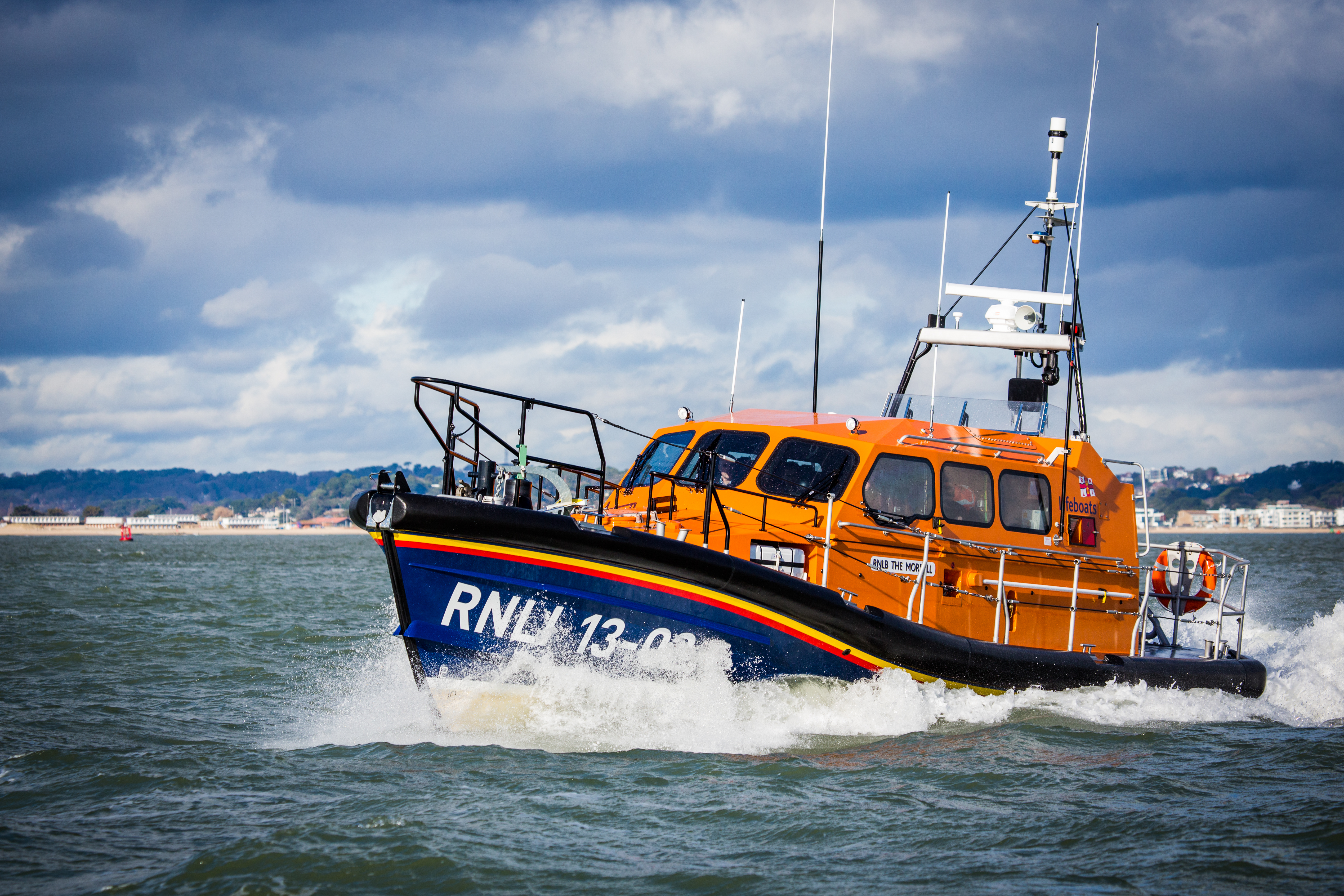 A Shannon class lifeboat sailing through Poole Harbour