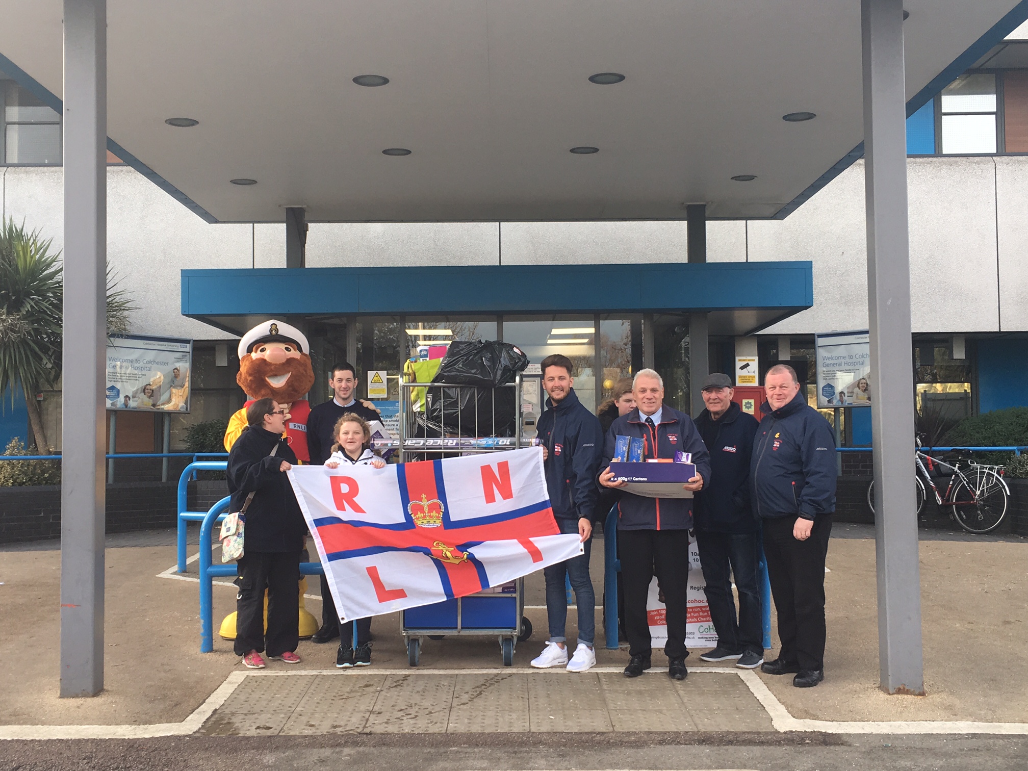 Crew standing outside Colchester hospital with donations for the children's ward