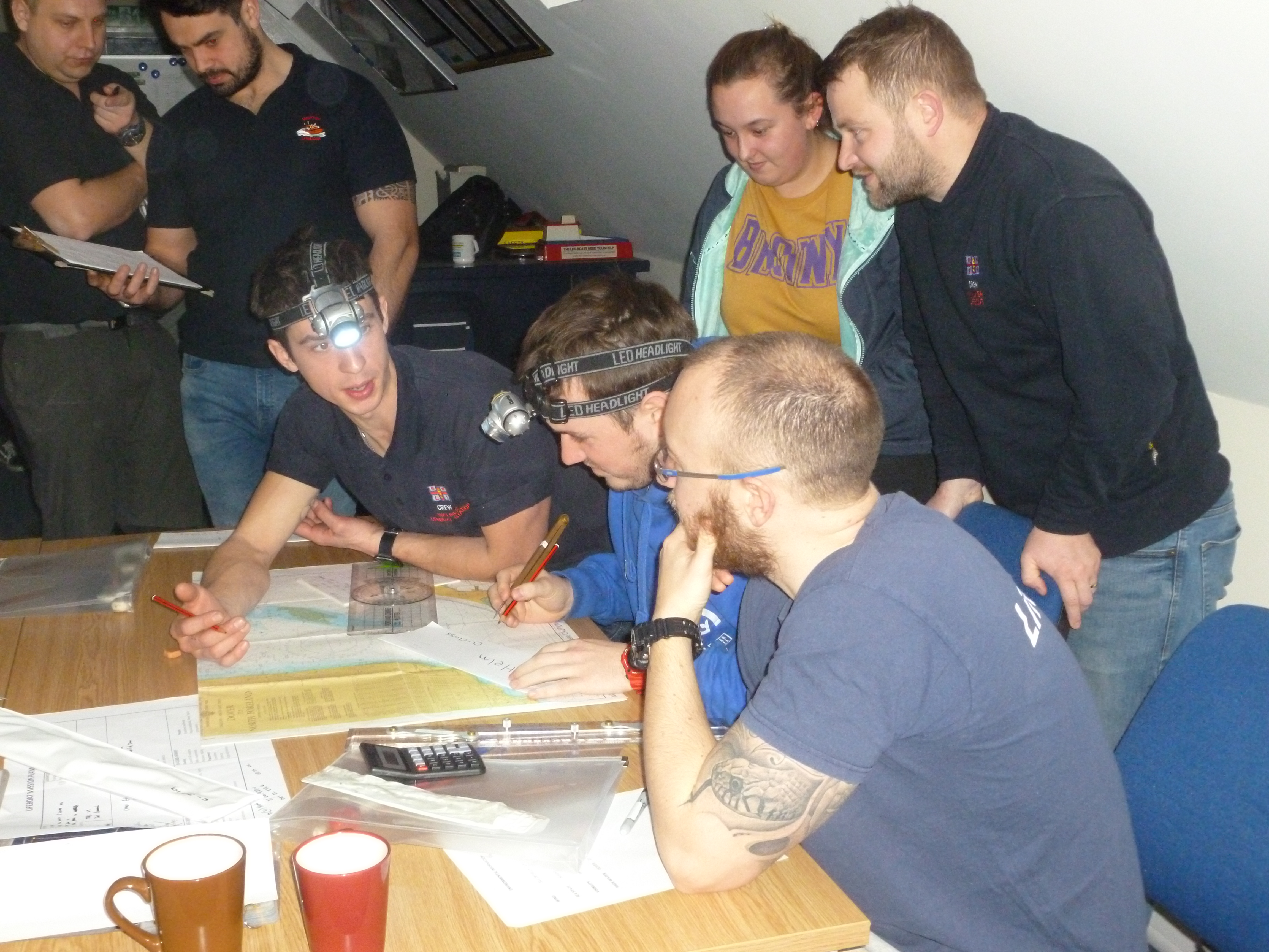 Crew plotting a course to the casualty vessel.