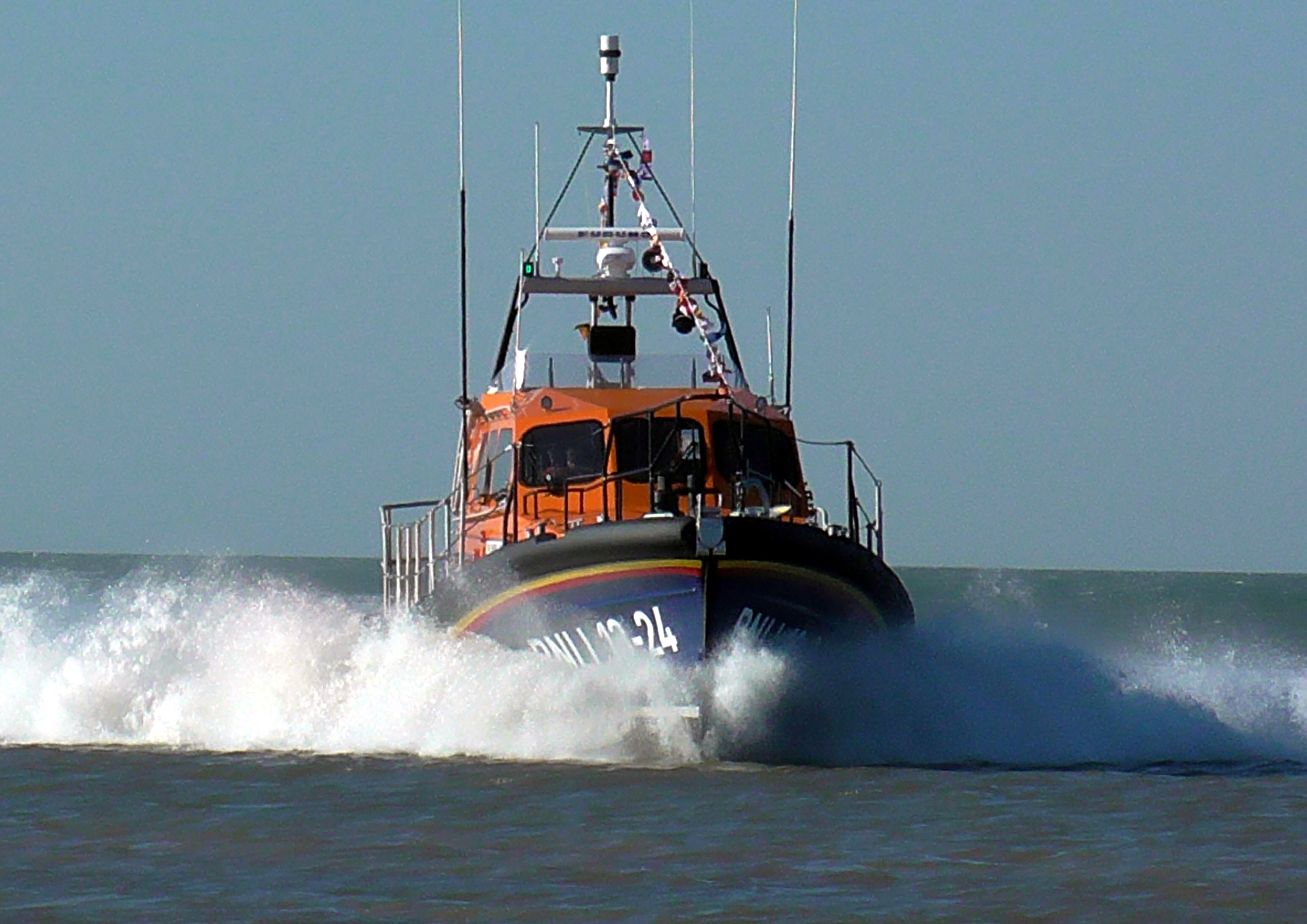 a lifeboat heads towards the viewer at speed