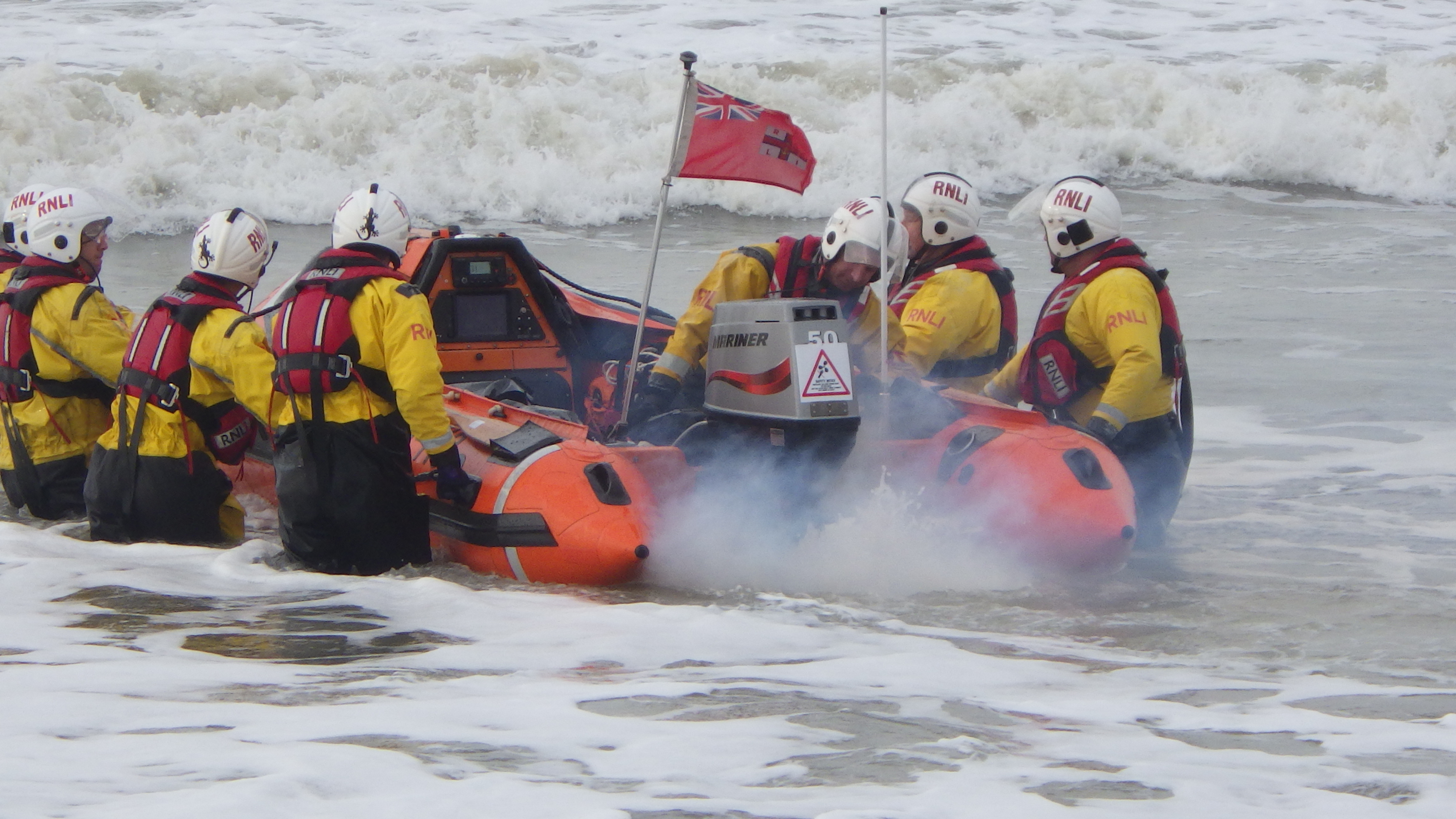 The lifeboat being launched into a choppy sea.