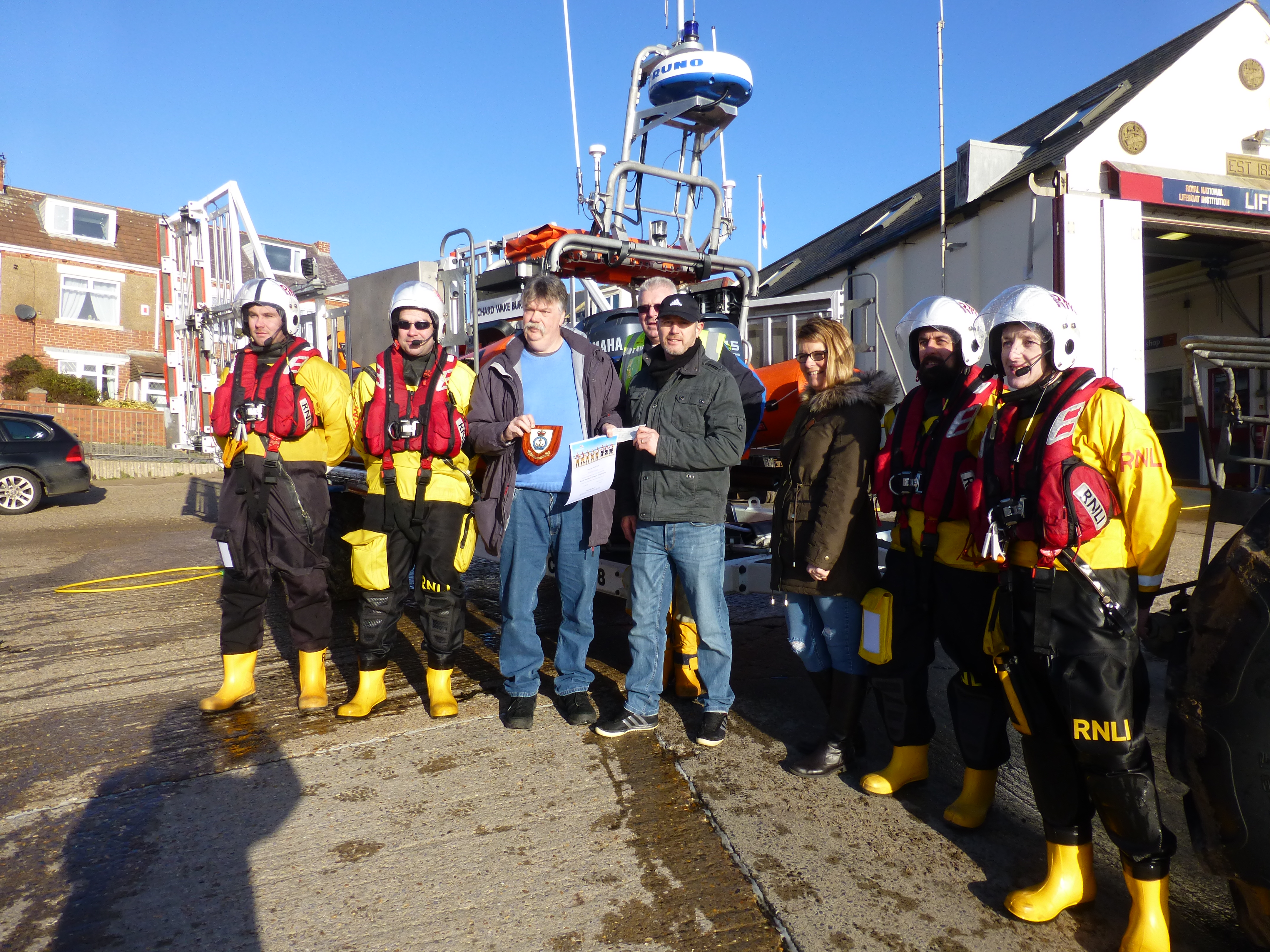 Mark and his wife presenting the cheque to the Newbiggin volunteers