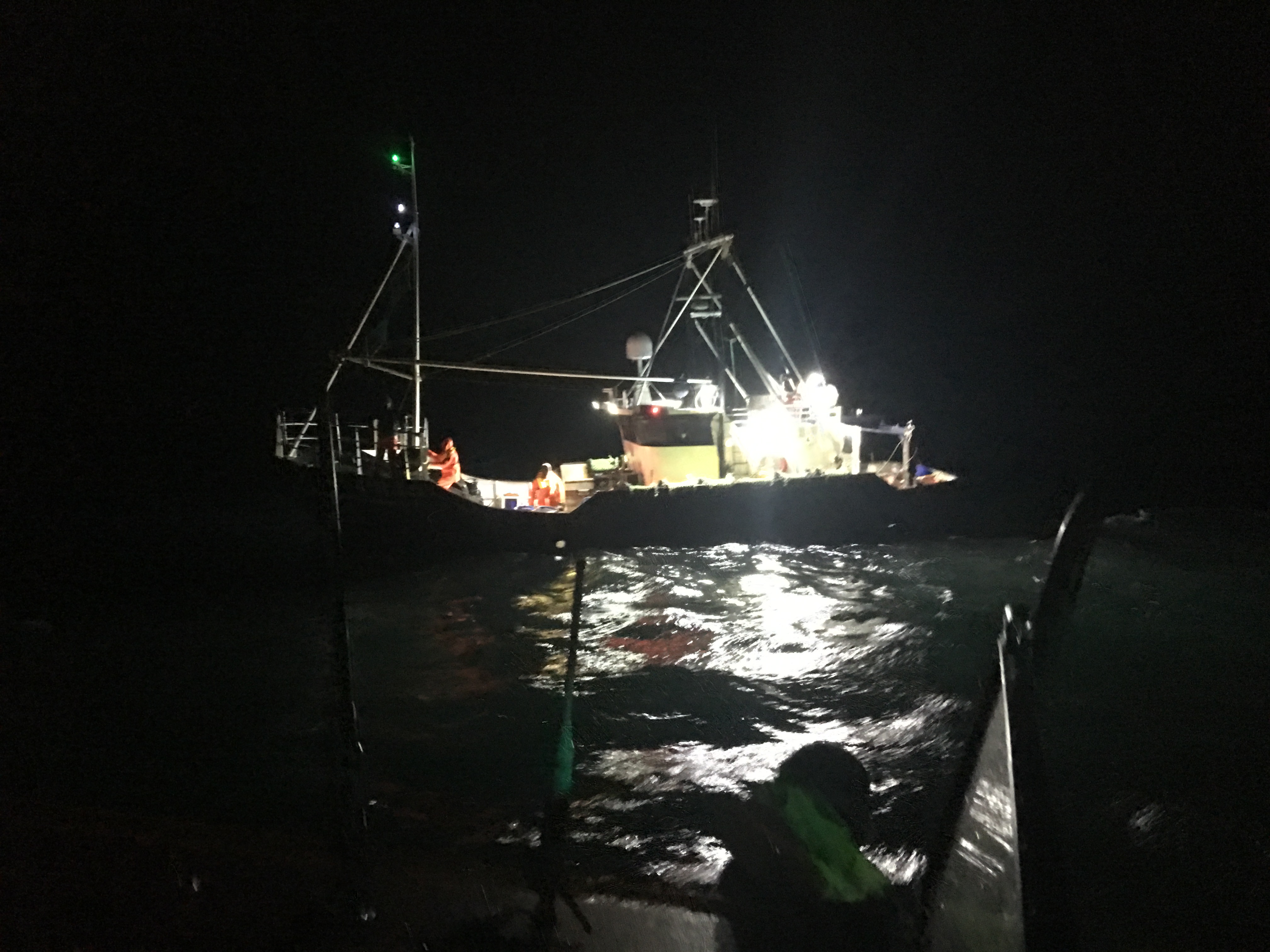 Fishing vessel Radiant waiting to be taken to Scarborough at night.