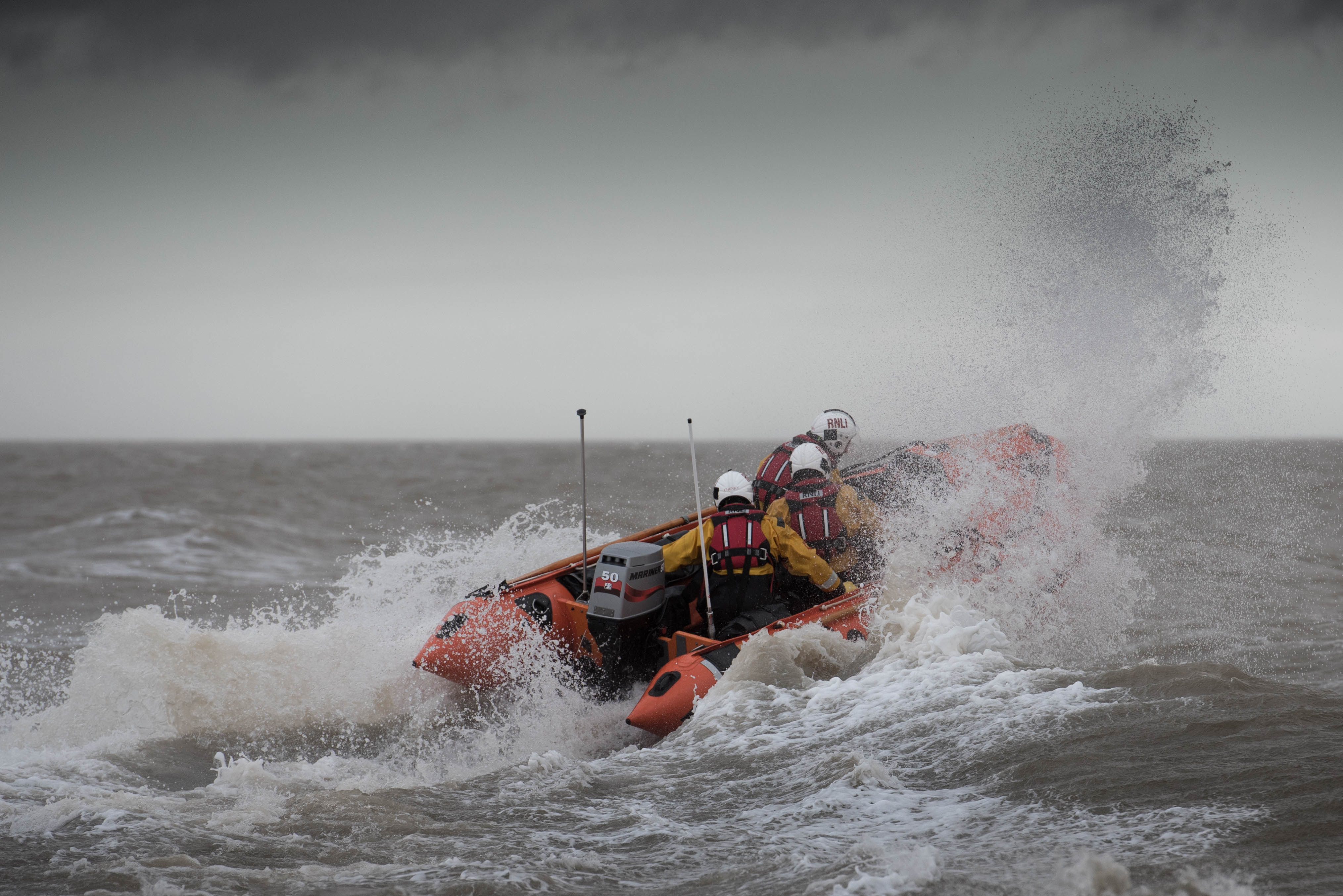Damarkand IV in surf with 3 crew members on board