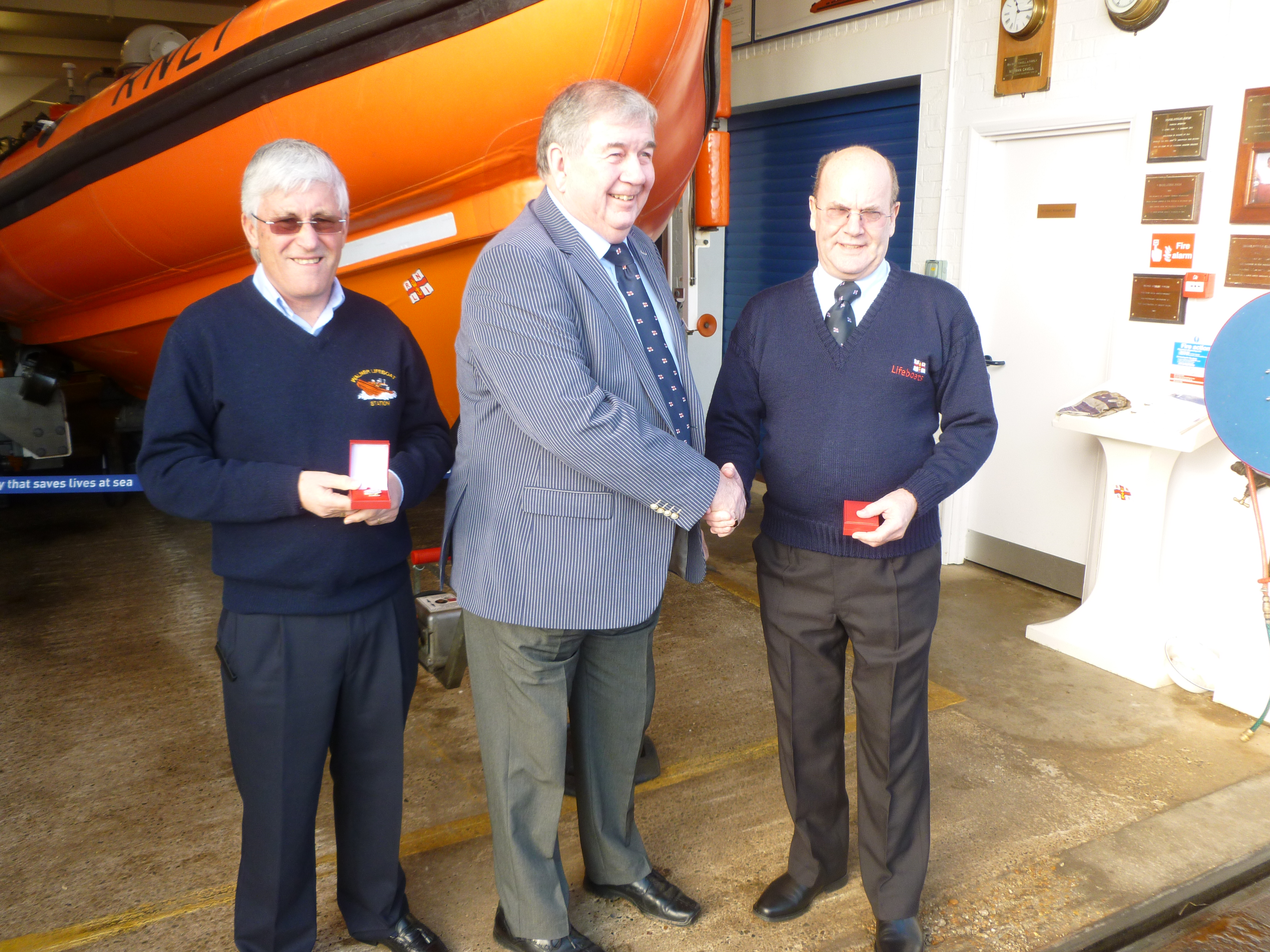Lifeboat Operation Manager Denis Brophy and Administration Officer Andy Worwood receive long service awards from Station Chairman Roger Blown.