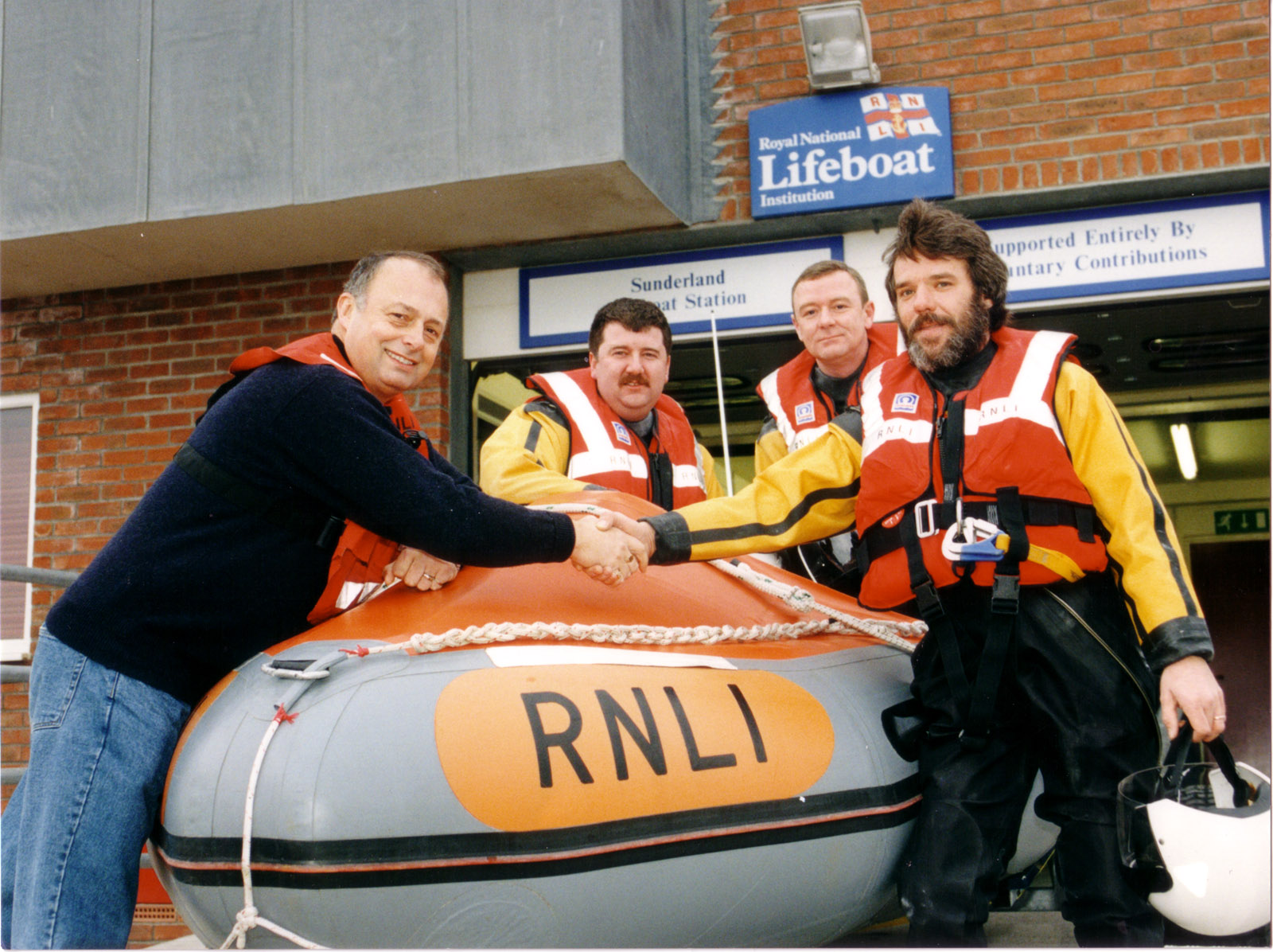 Fisherman rescued in 1998 returns to the lifeboat station to say thank you. (Lifeboat crew Martin Barry, Mike Cowe, and Brian Barkess)