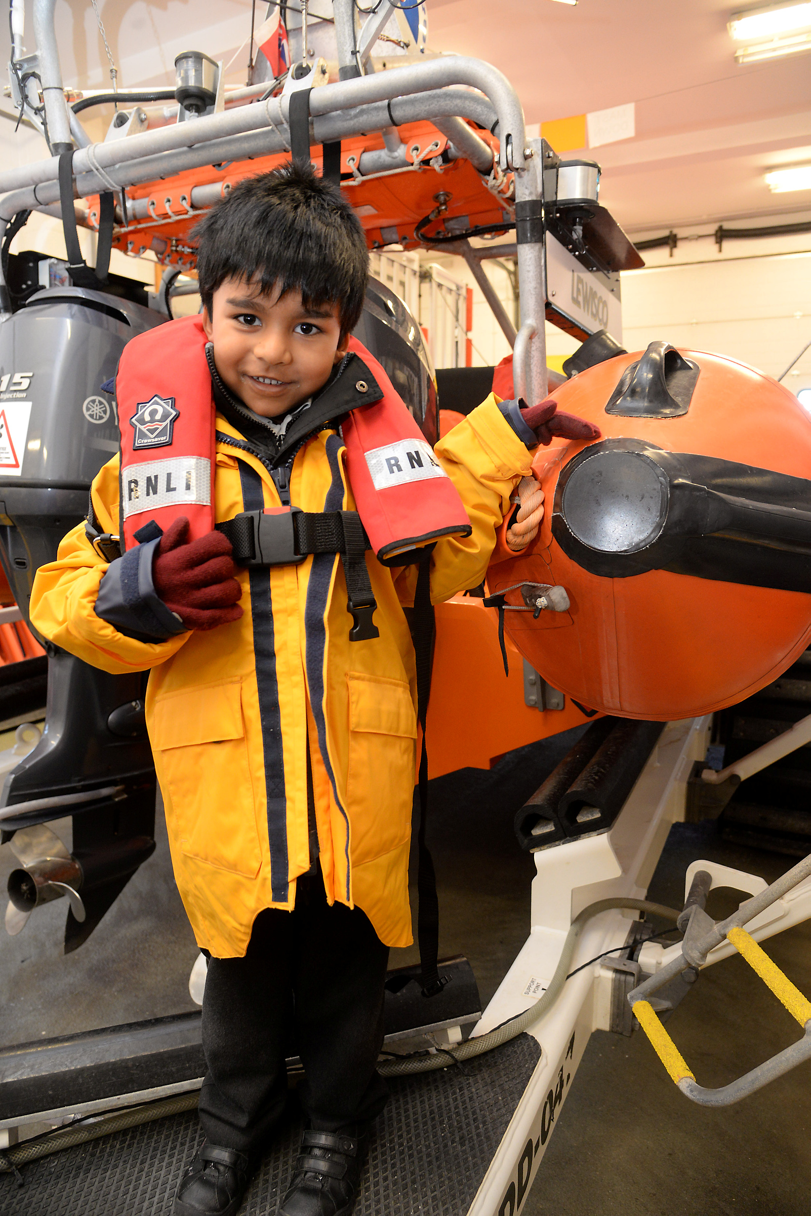 Ollie, five, dressed as a lifeboat crewmember when he visited Whitstable Lifeboat Station with the Reception Class from Kent College. Picture: RNLI Whitstable.
