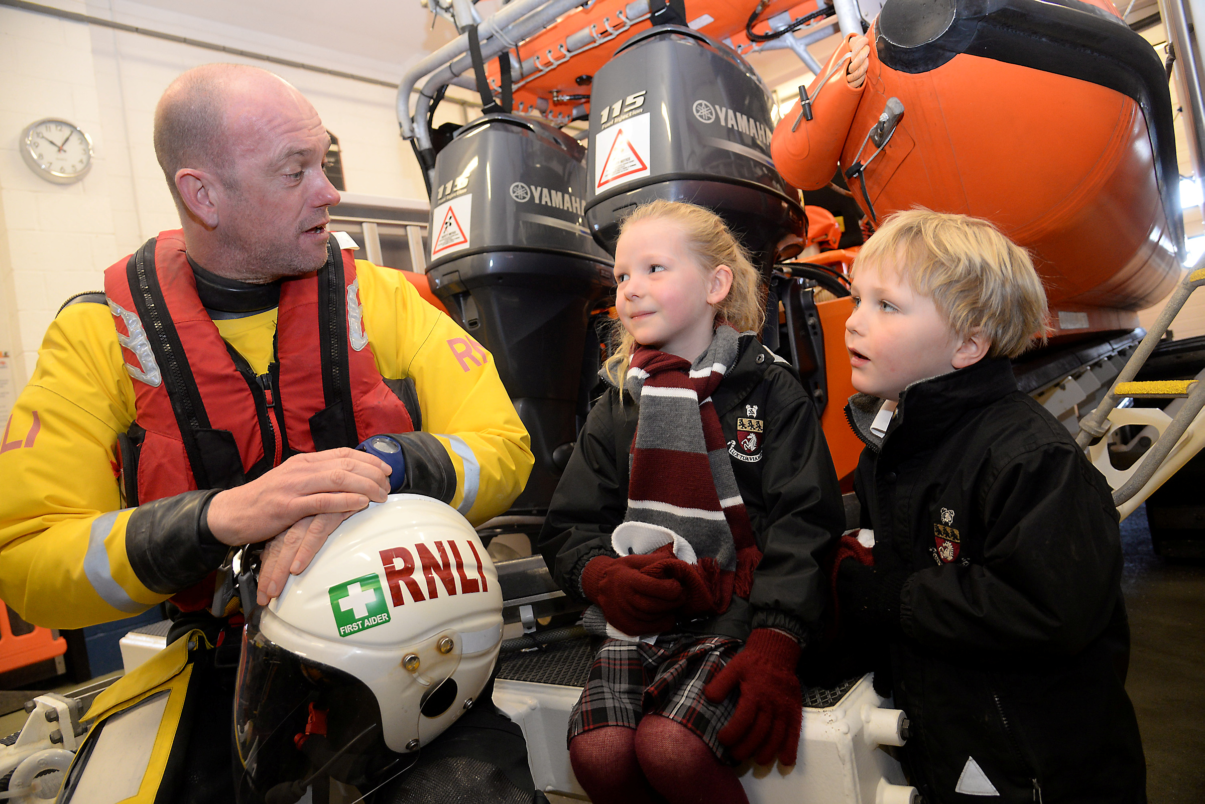 Crewmember Adrian Woolrich-Burt talks to Ellie and Kitt, both five when they visited Whitstable Lifeboat Station with the Reception Class from Kent College. Picture: RNLI Whitstable.
