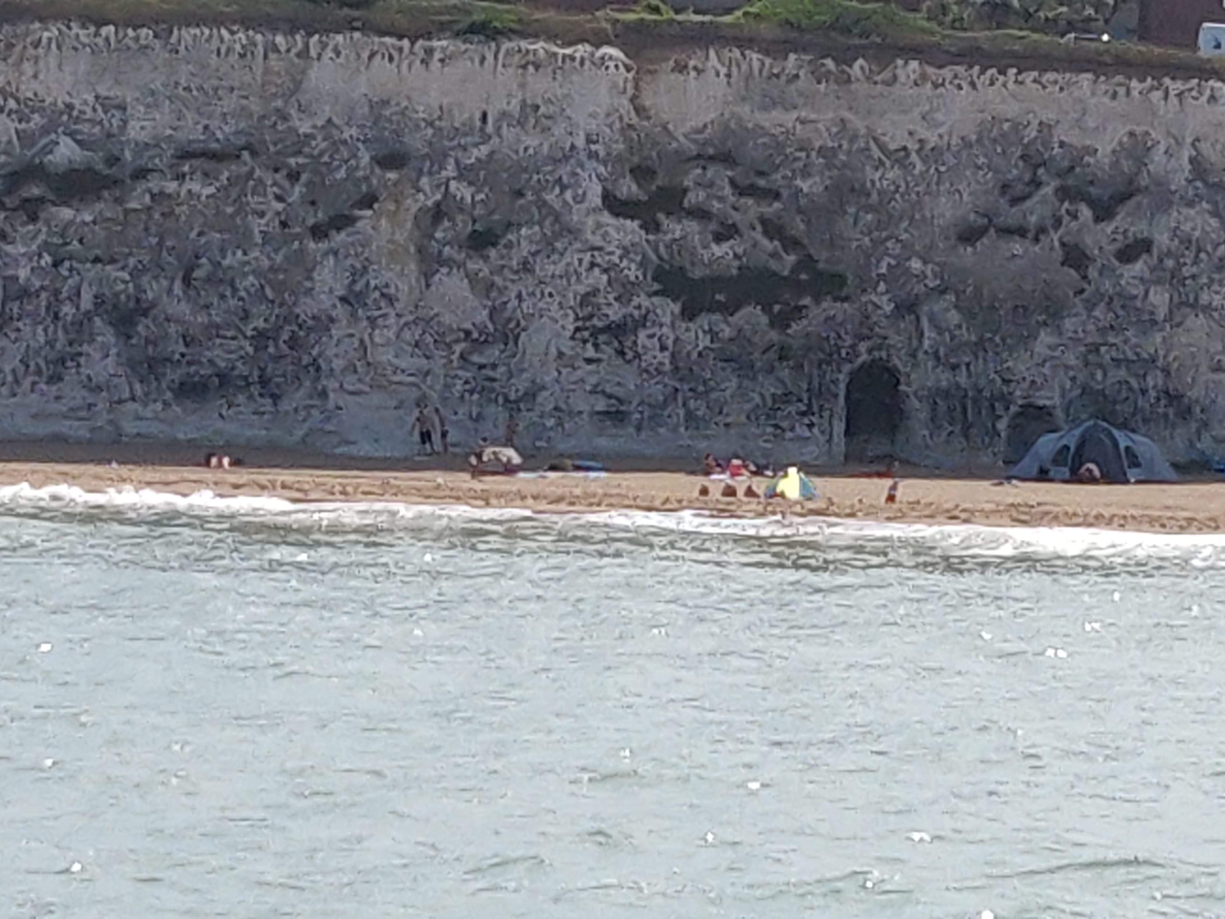 Beach-goers cut off by the tide