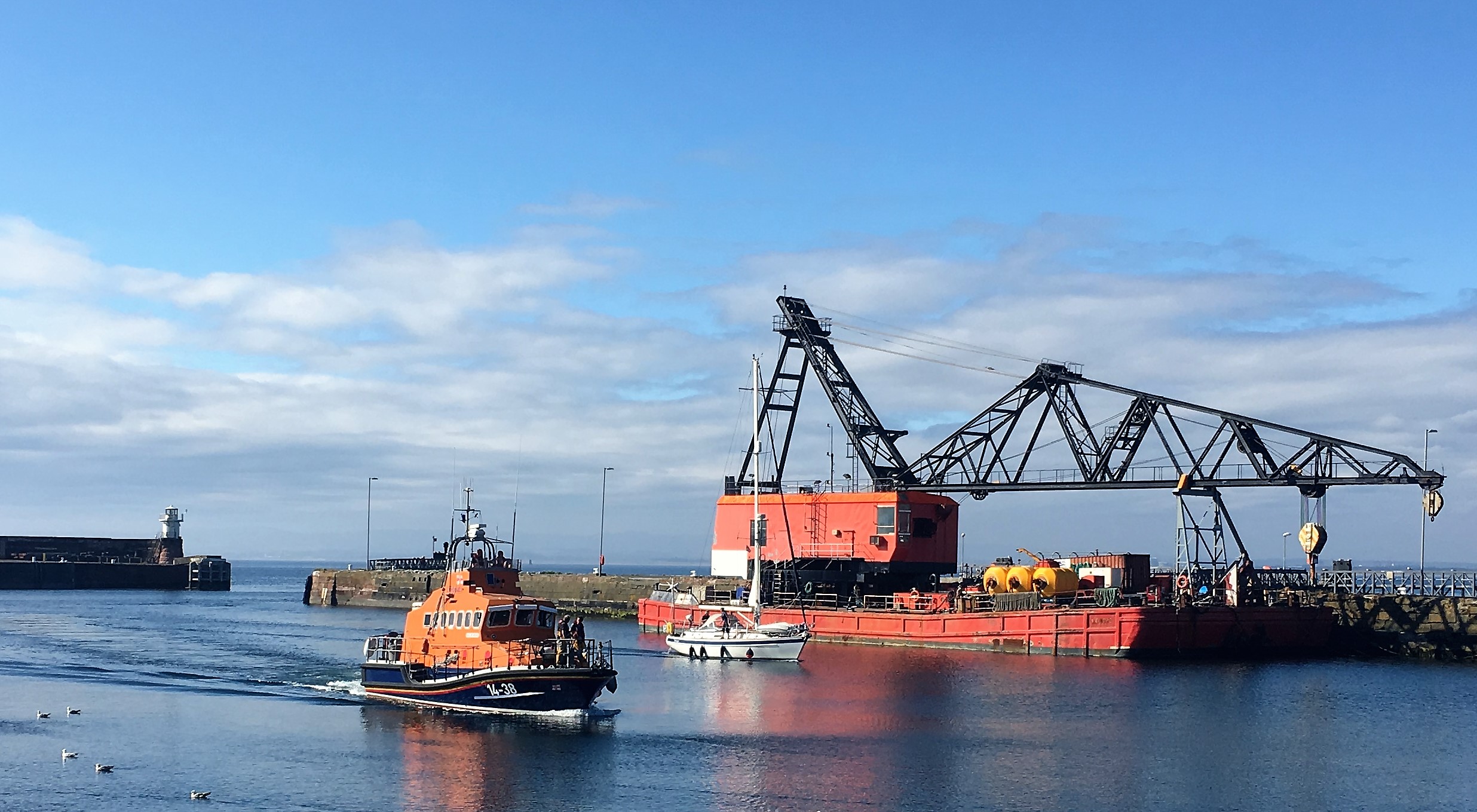 Within Troon harbour, Troon all-weather Trent class lifeboat escorting the yacht
