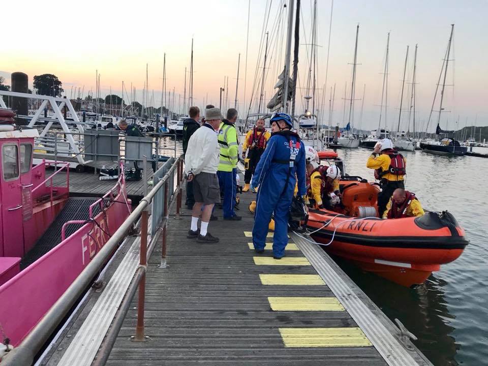 RNLI crew safely transferring casualty over to emergency services