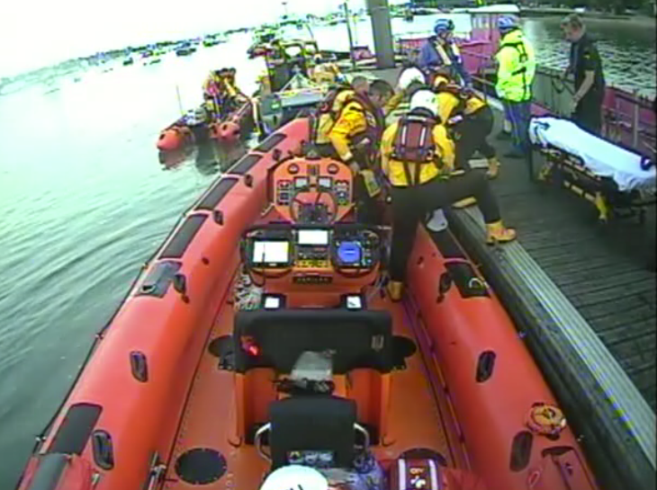 Calshot RNLI transferring casualty to Ambulance Service on pontoon