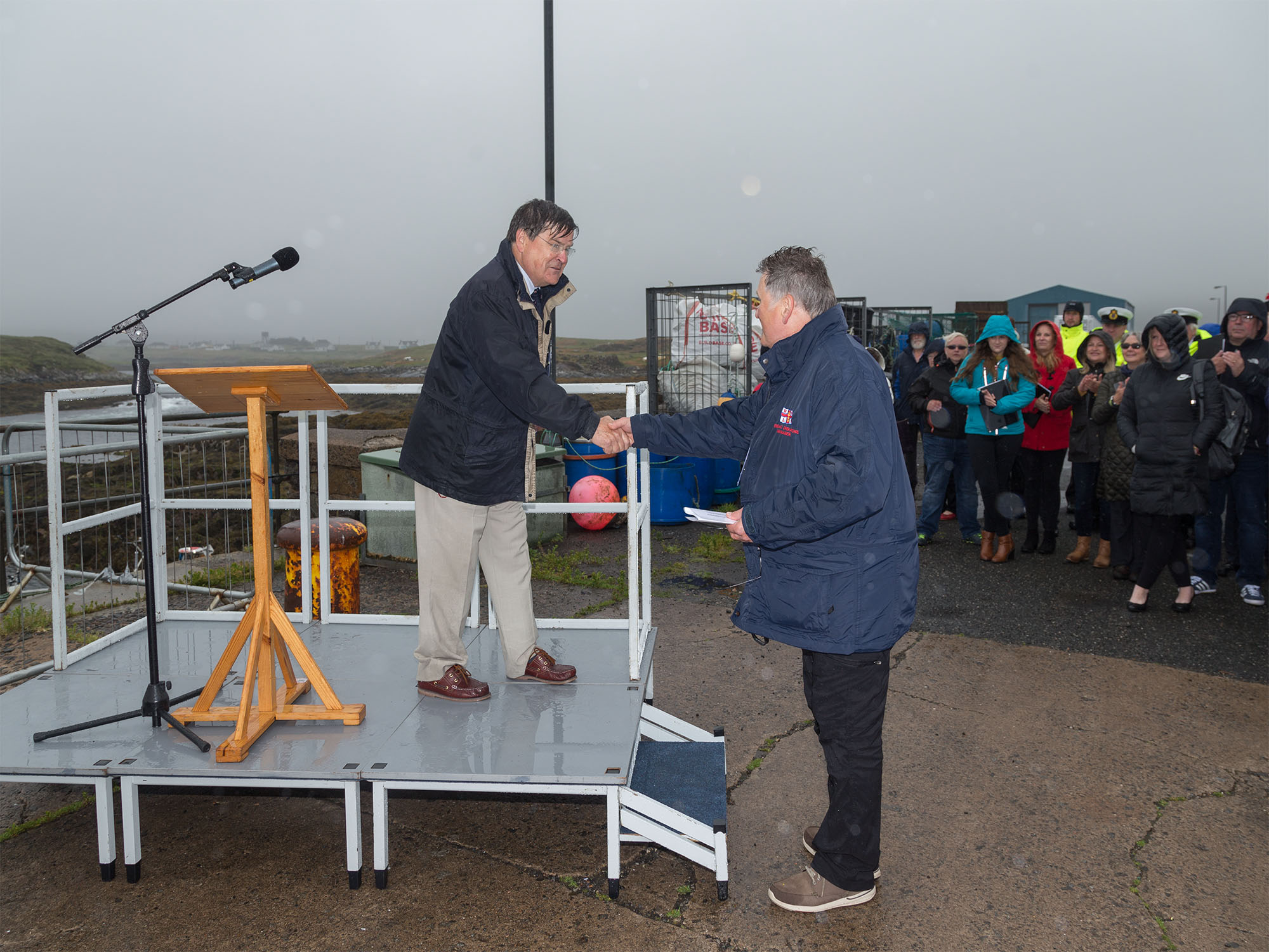 Roger Lockwood and Chris Ross shake hands on the platform