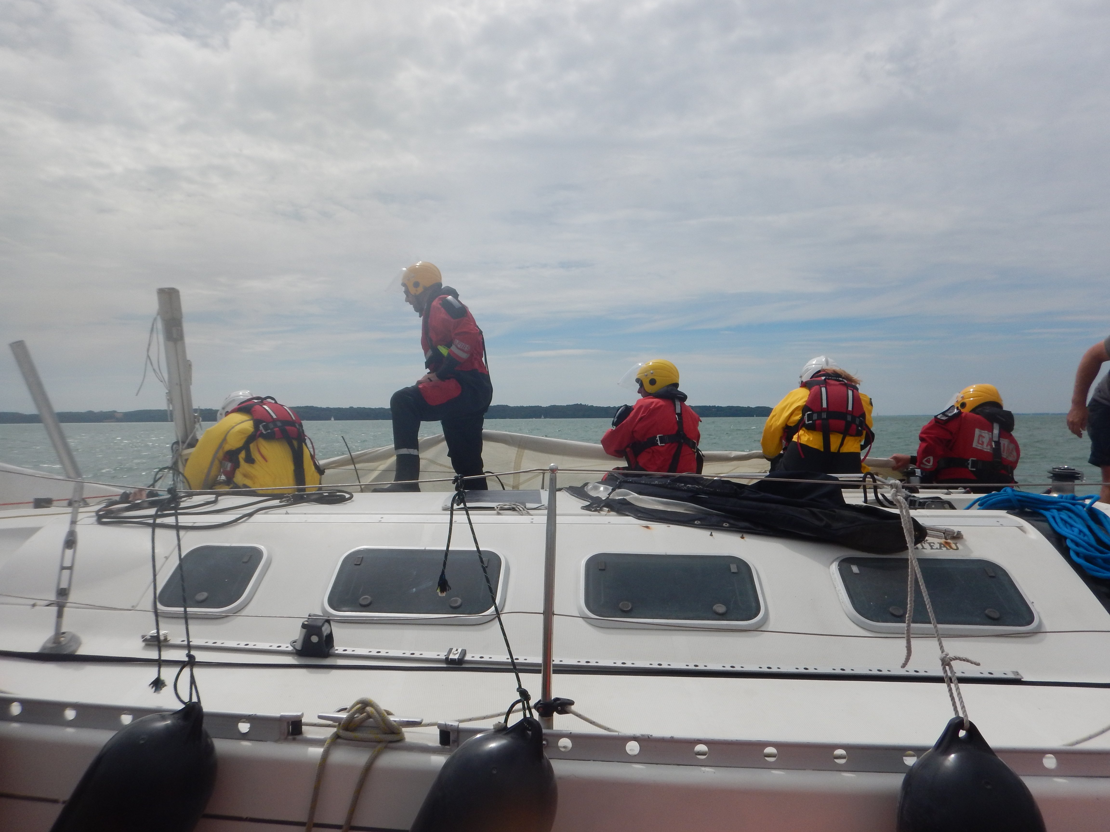 Lifeboat crew members swarm over the yacht.