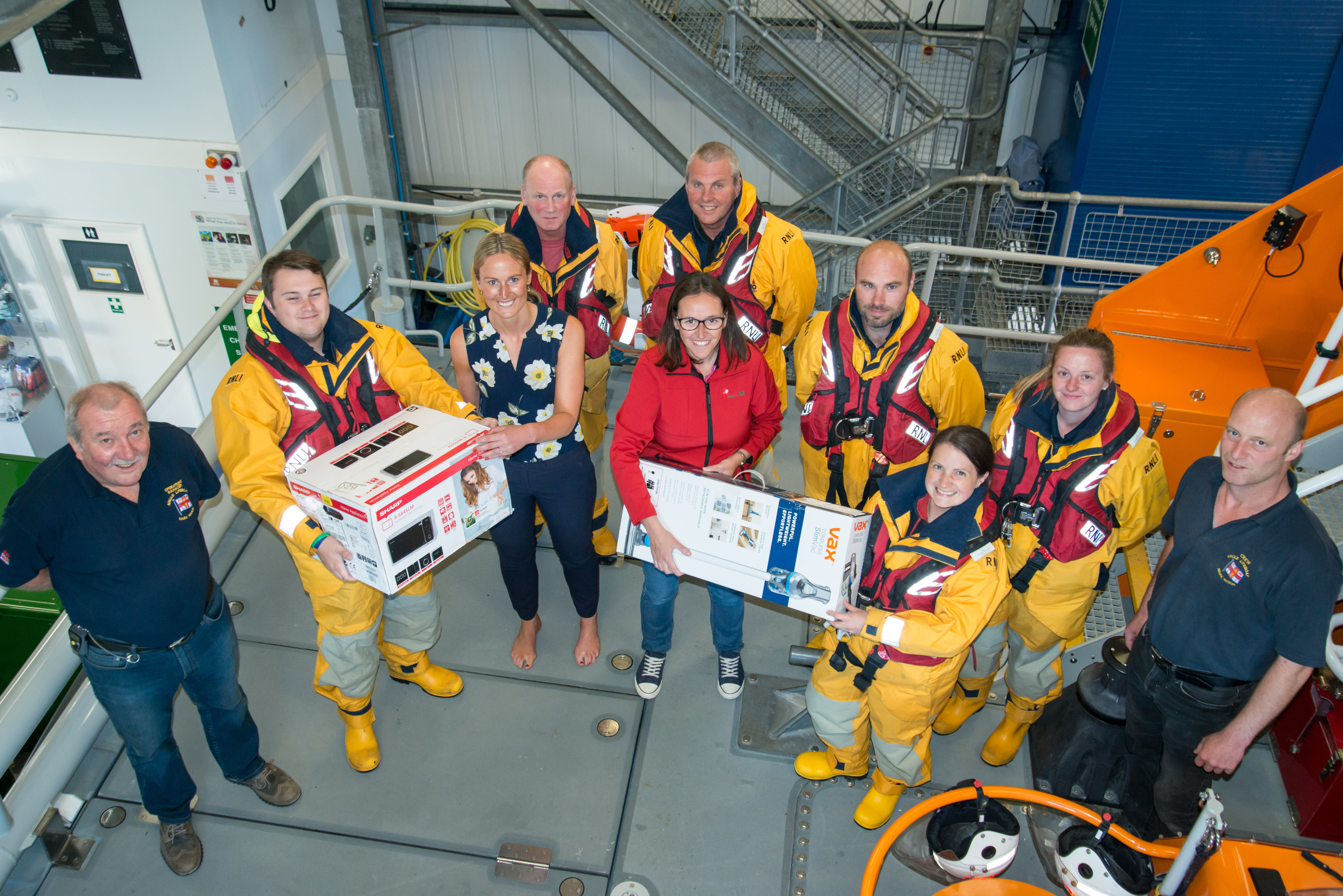 Dragon LNG representatives Lynette Round and Laura Callan are pictured on board Angle RNLI’s Tamar class all weather lifeboat with Julian Hammond, Lifeboat Operations Manager; Coxswain Lewis Creese and crew members.
