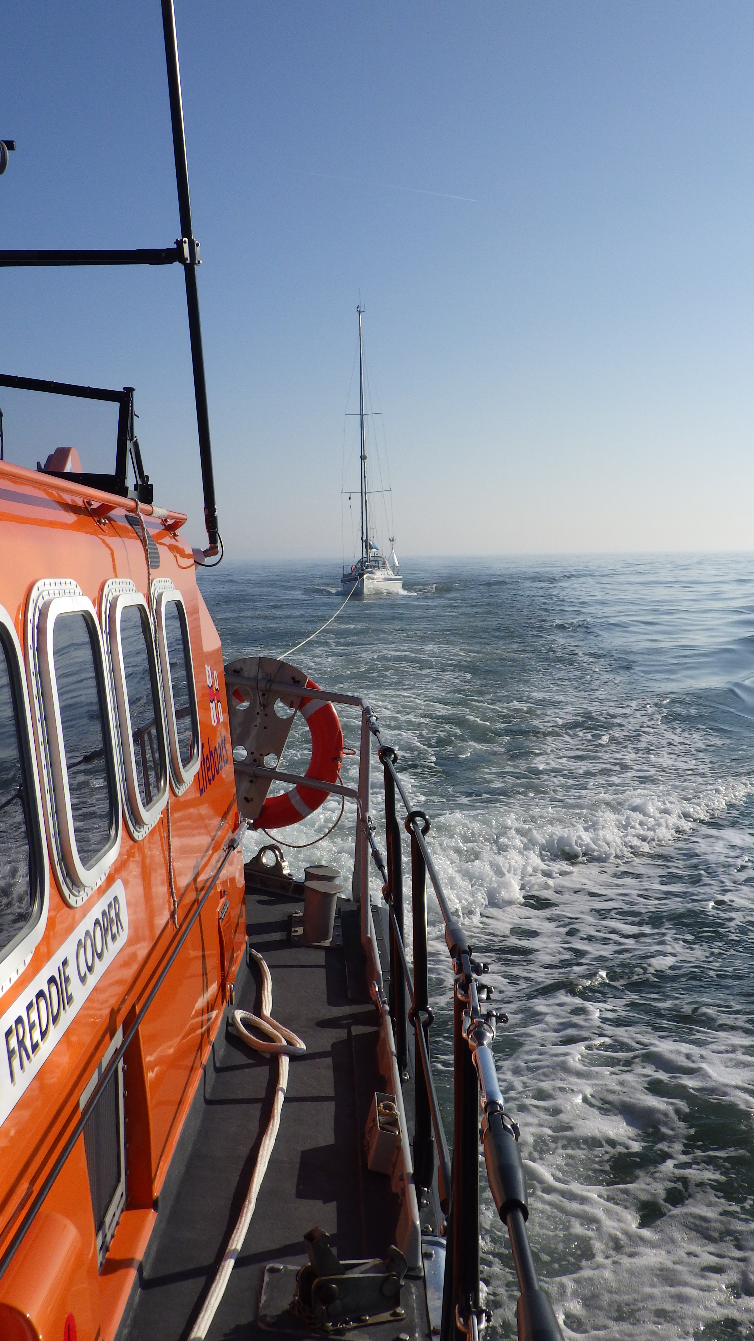 The all weather lifeboat is towing a yacht that had engine failure and was becalmed
