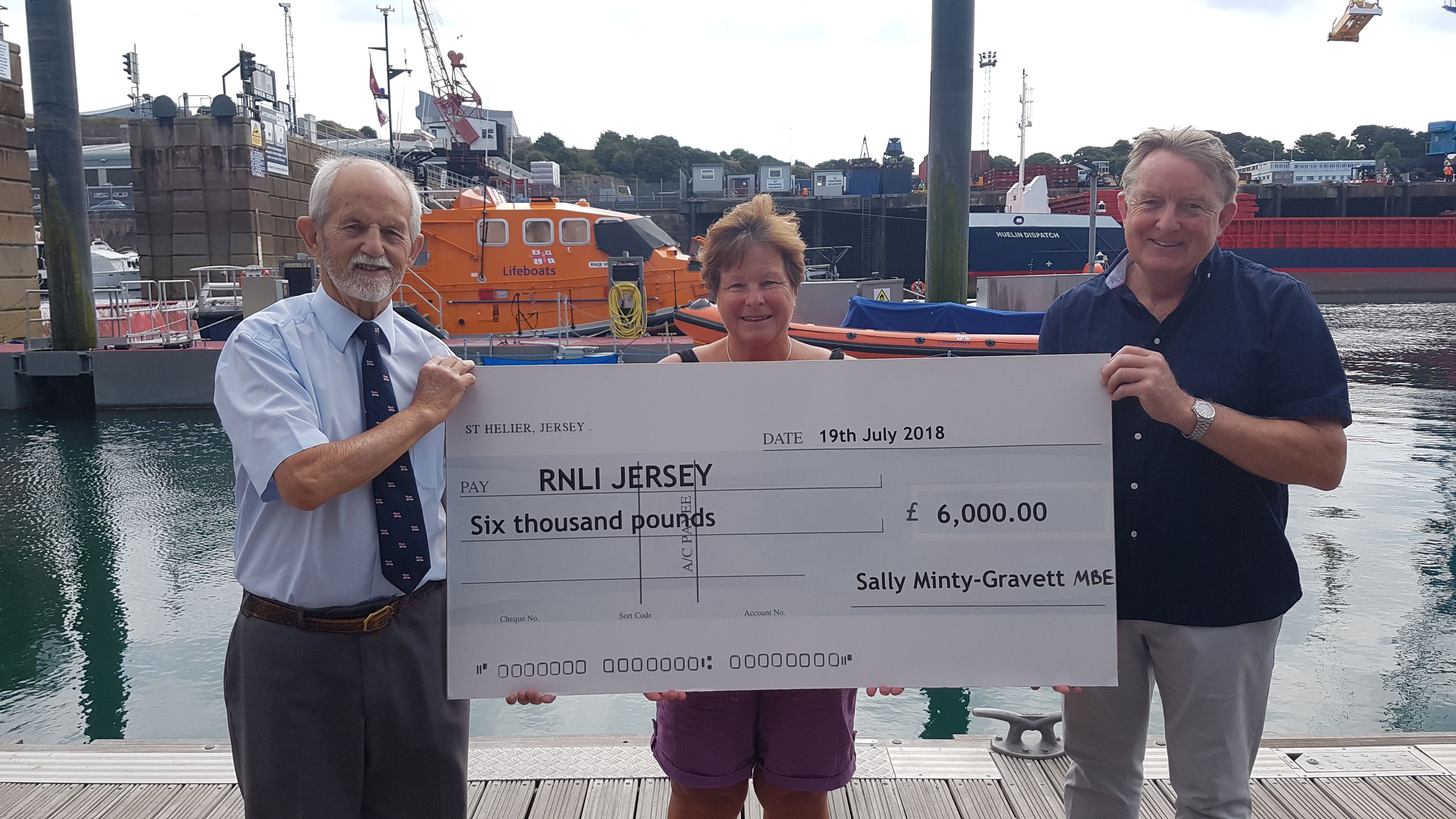 Sally Minty-Gravett, MBE presents her cheque to RNLI Jersey