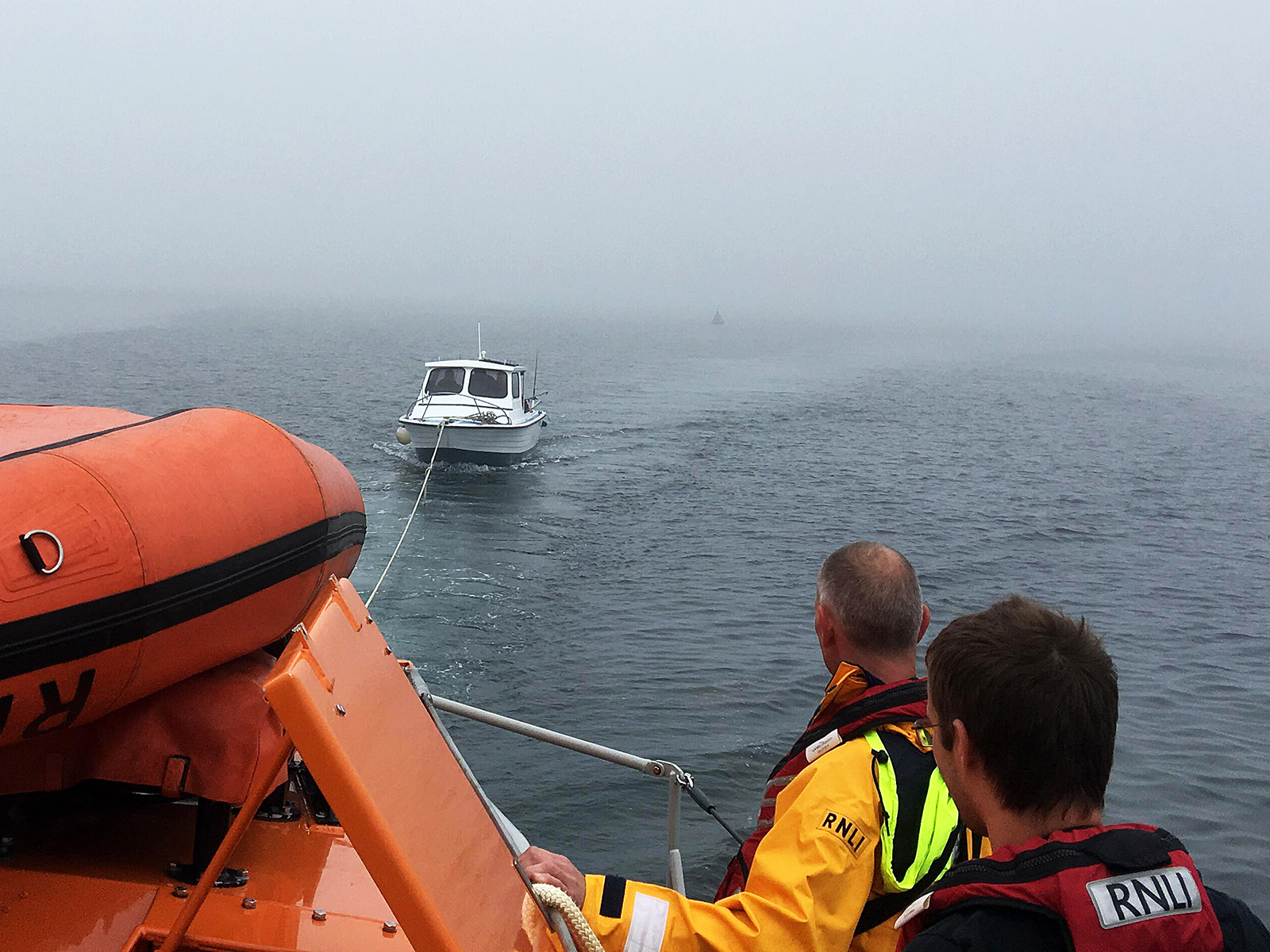 Douglas all-weather lifeboat Sir William Hillary with casualty vessel under tow