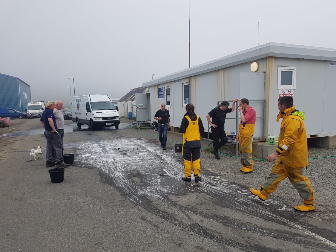RNLI crew washing cars outside their station