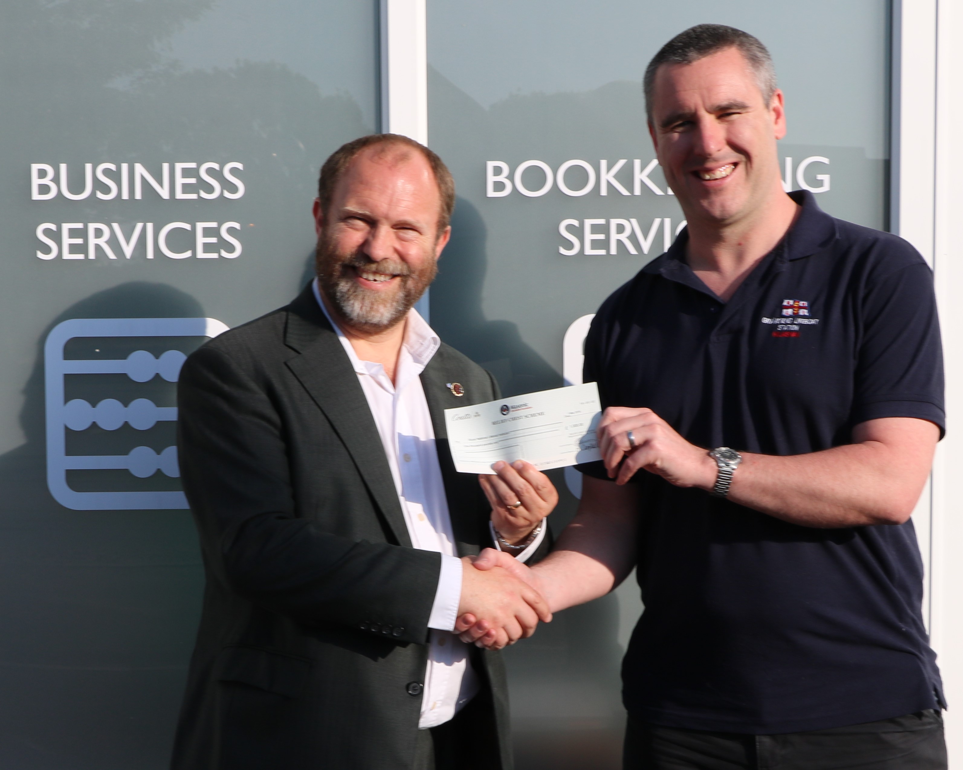 Jonathan Vowles on behalf of The Cannon Lodge handing a cheque over for £1000 to Chris Maher, volunteer Helmsman at Gravesend RNLI