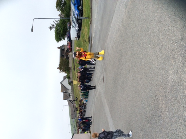RNLI crew members parade down to pier