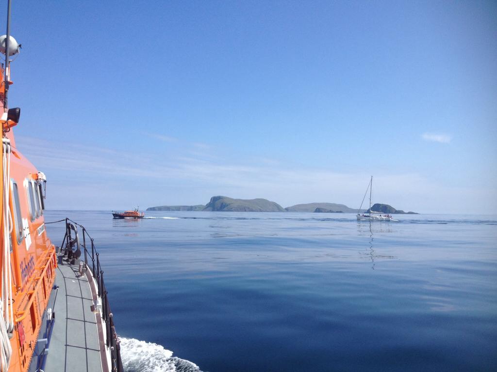Picture taken from on board the stornoway Lifeboat. Leverburgh Lifeboat towing the yacht with islands in the background.