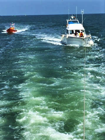 The casualty craft under tow from the Sheerness all weather lifeboat with the Southend crew in the background as escort.