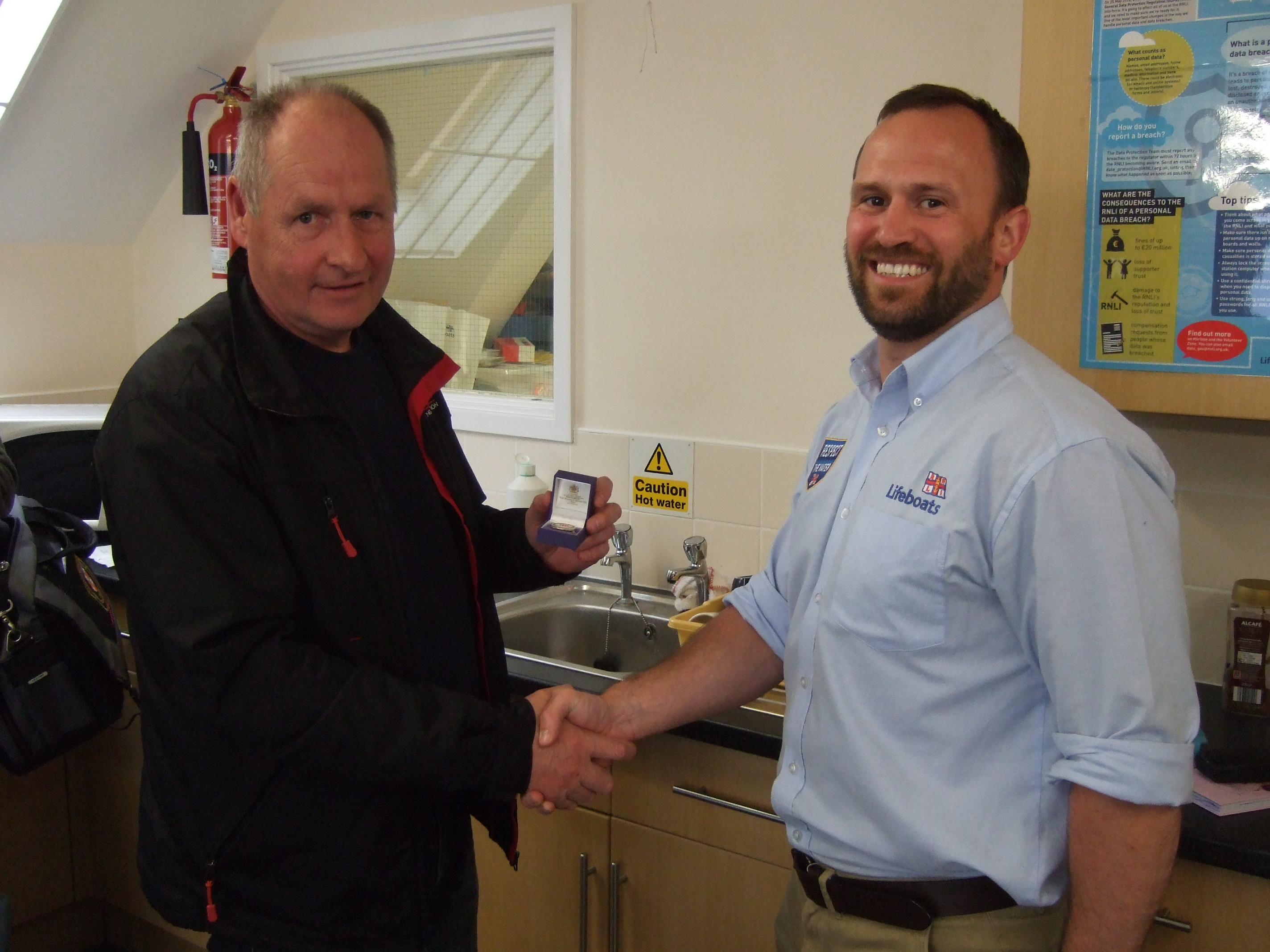 Rod (left) receives the award off ALM Carl Harris