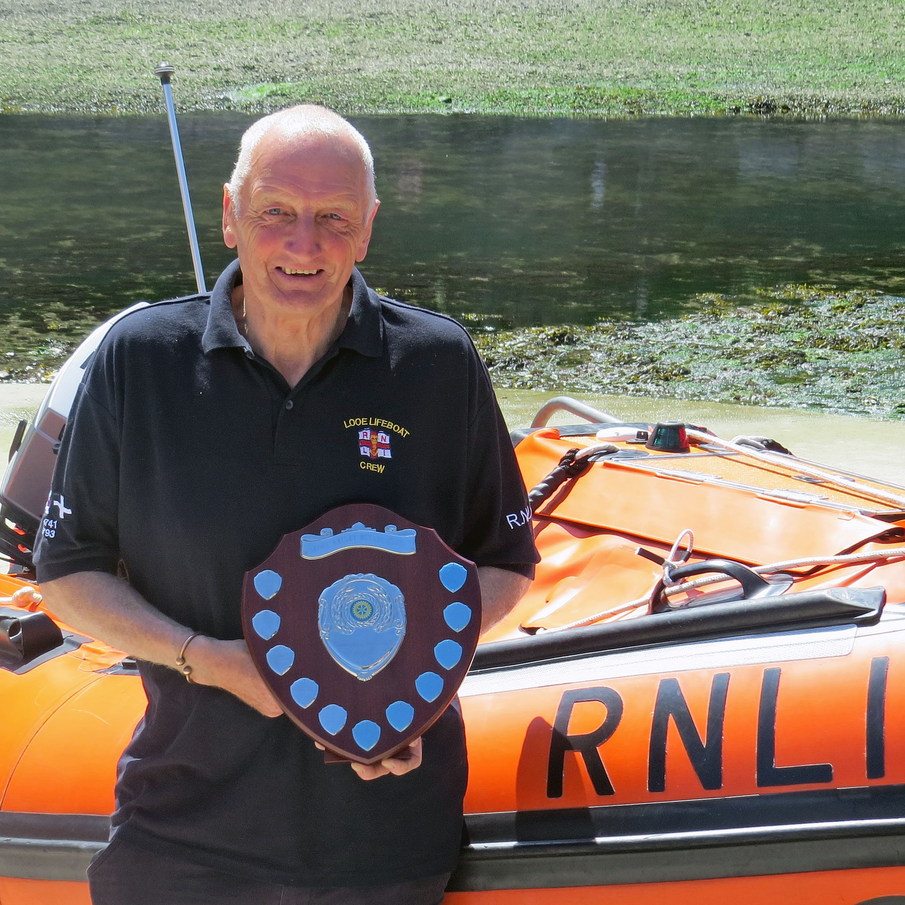 Looe RNLI Lifeboat Operations Manager David Haines with the award shield outside Looe Lifeboat Station