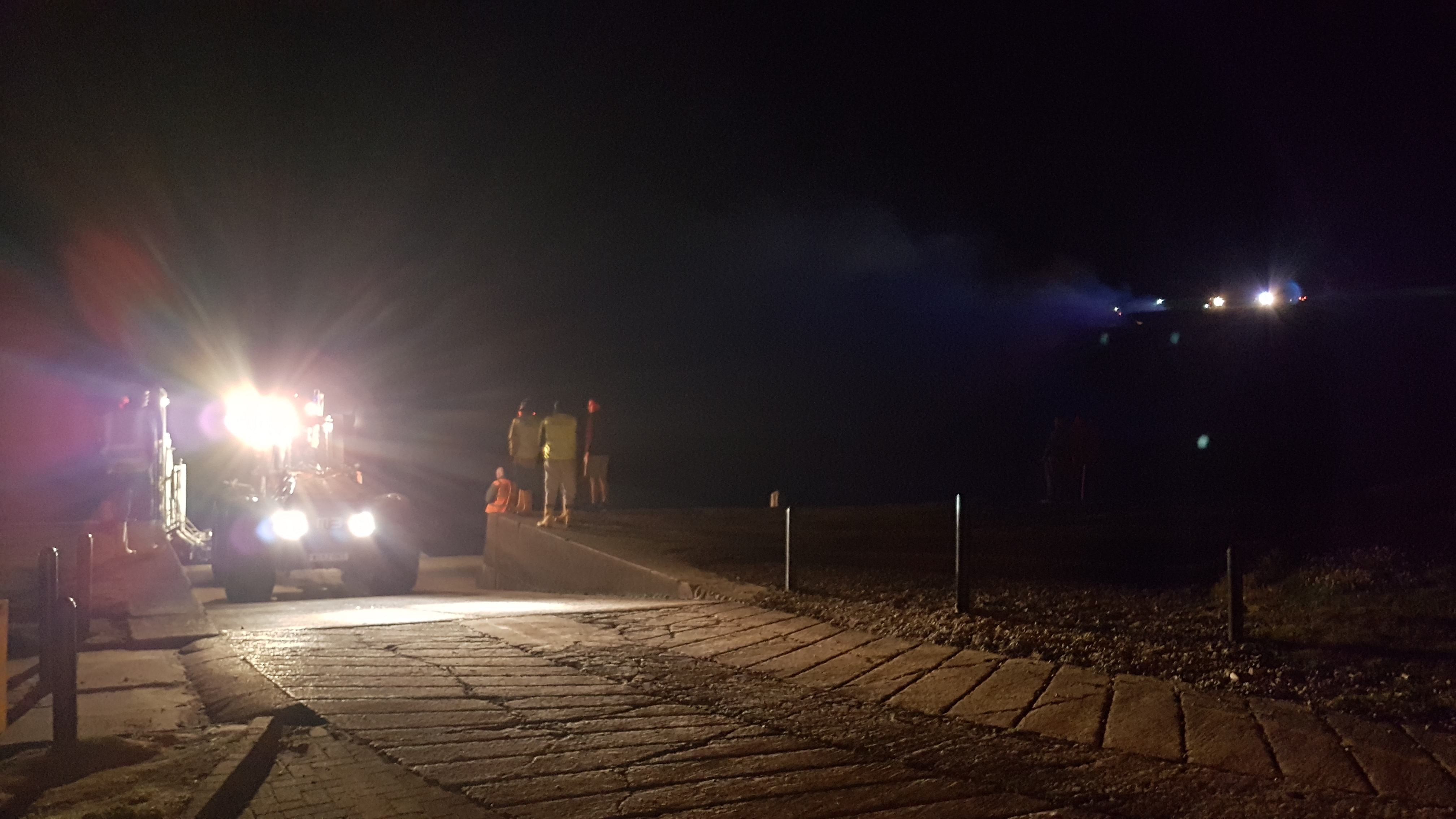 St Bees RNLI lifeboat returning to the station with the fire on St Bees Head still burning in the background.