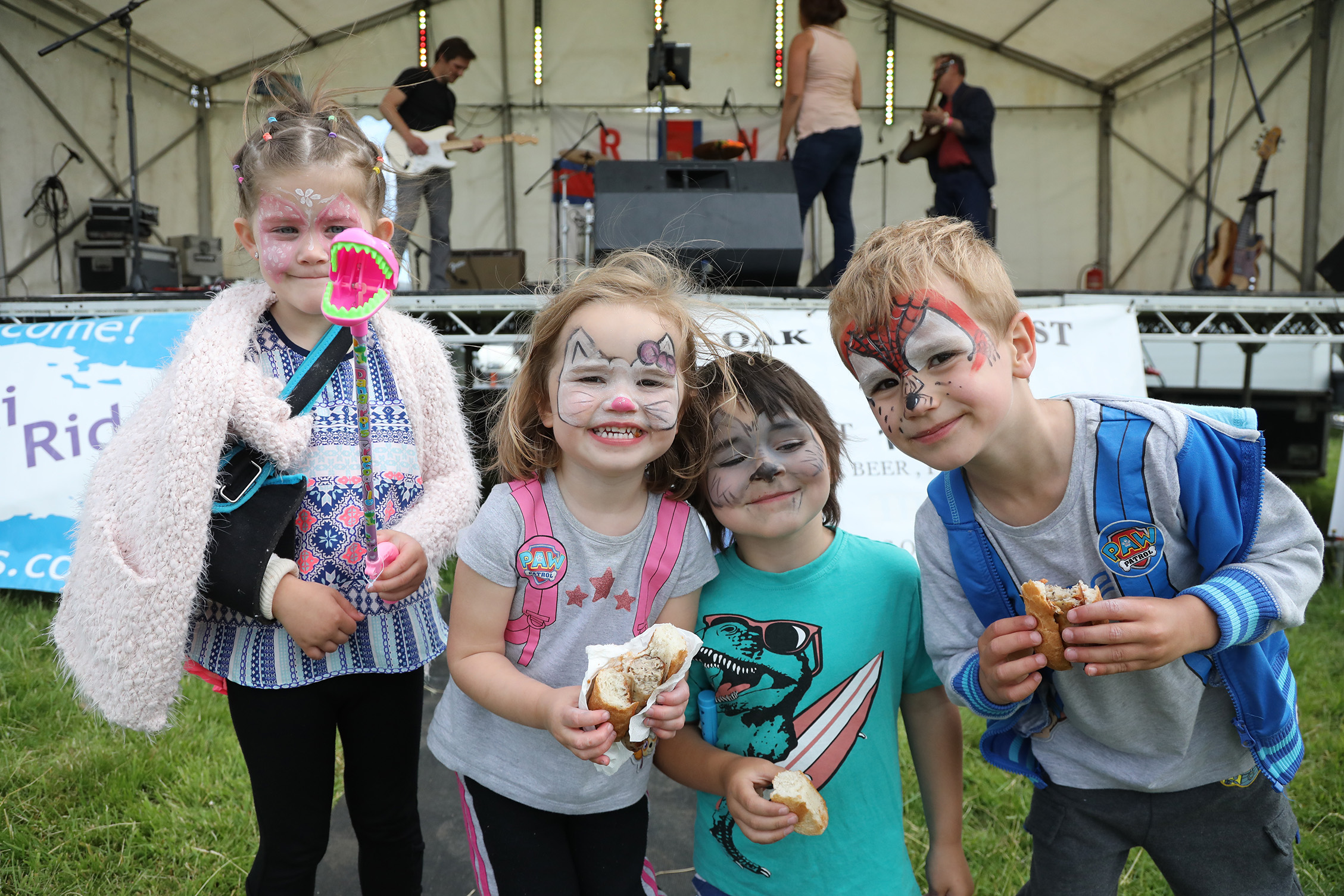 four very young children faces painted 