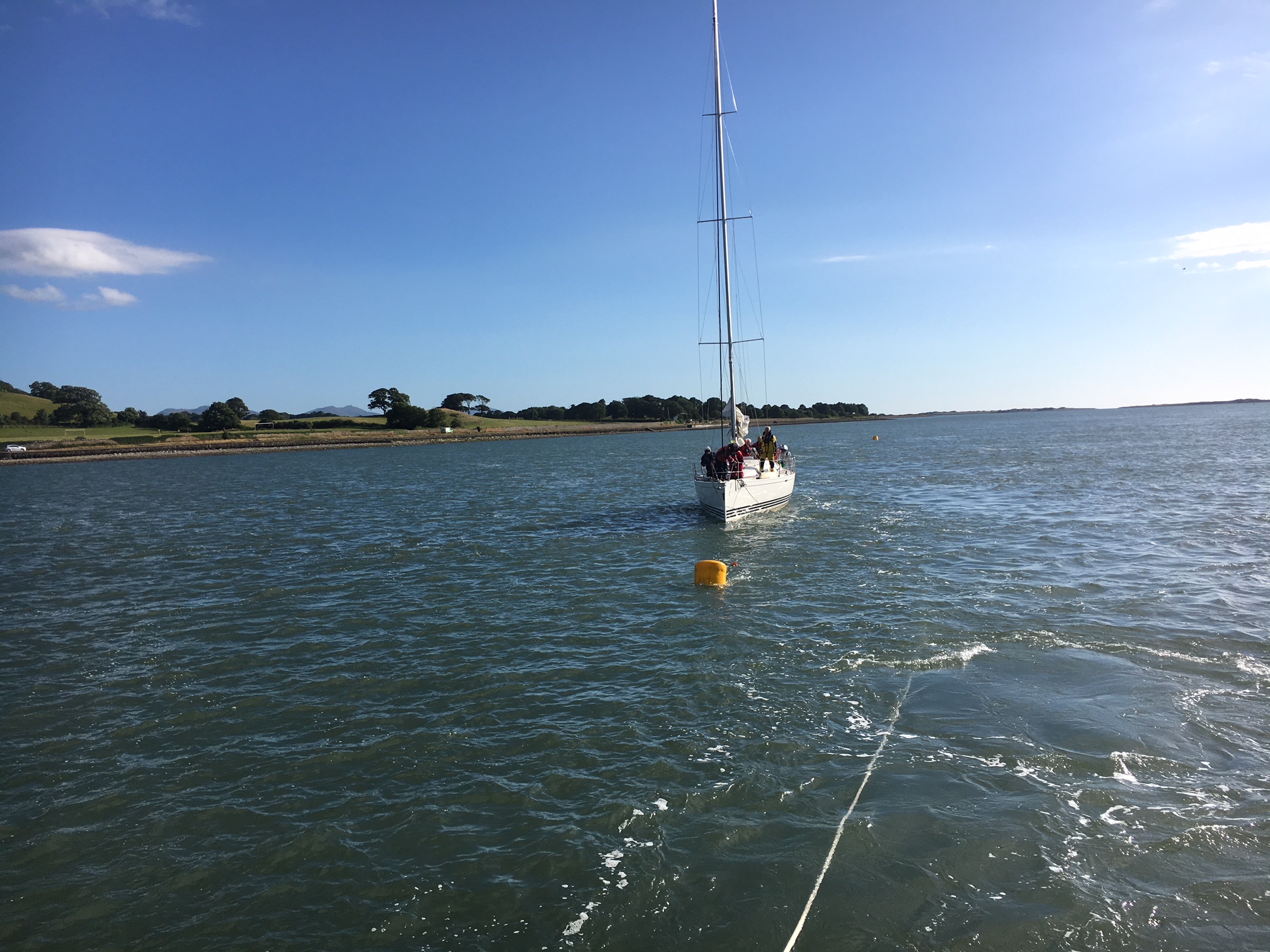 Yacht being placed on safe mooring near Caernarfon harbour