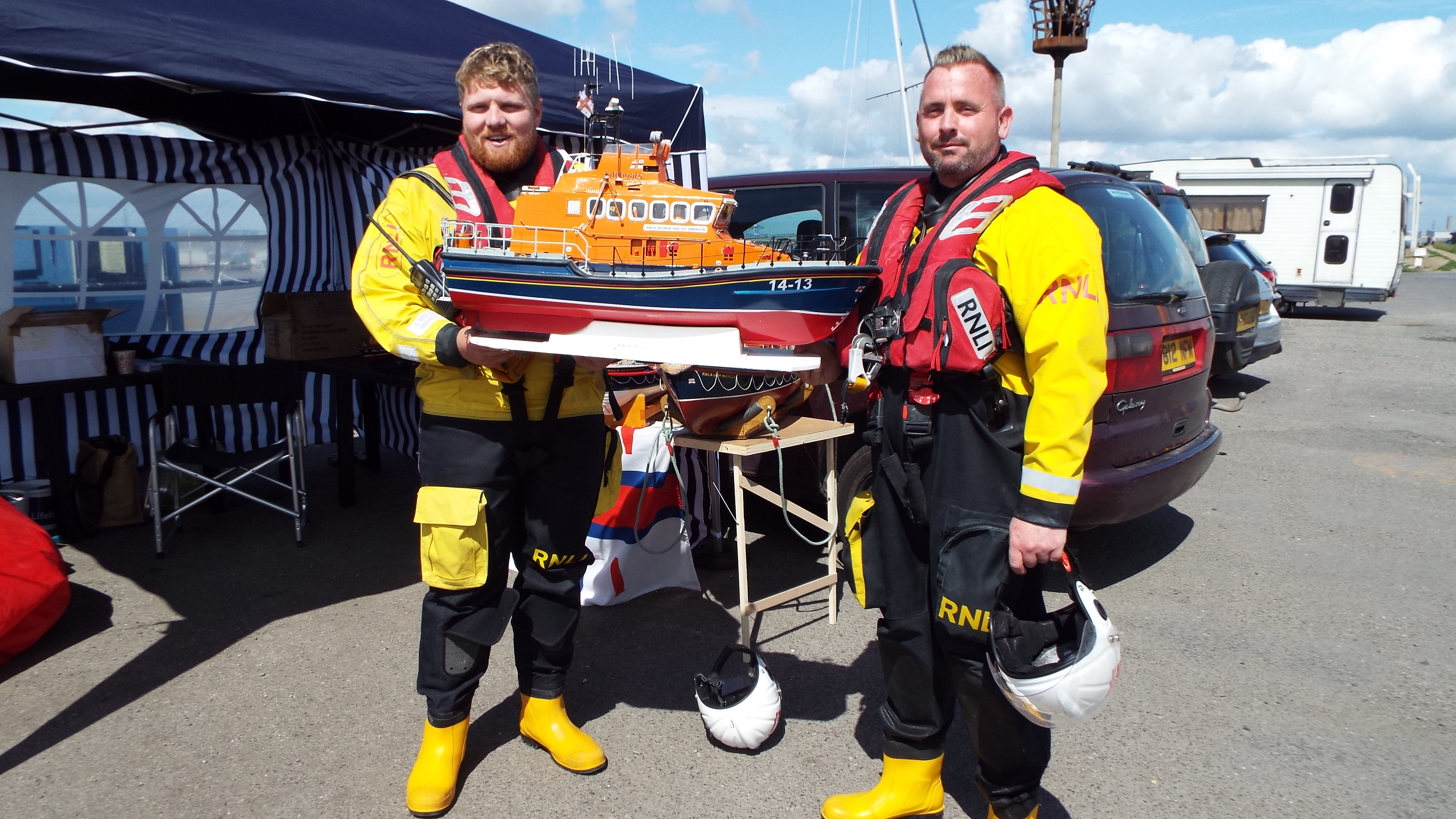 Crew members Luke and Damon pictured holding a full working model of The George and Ivy Swanson
