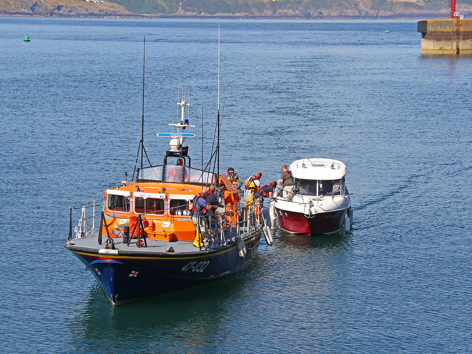 Douglas all-weather lifeboat Sir William Hillary with casualty vessel entering Douglas harbour