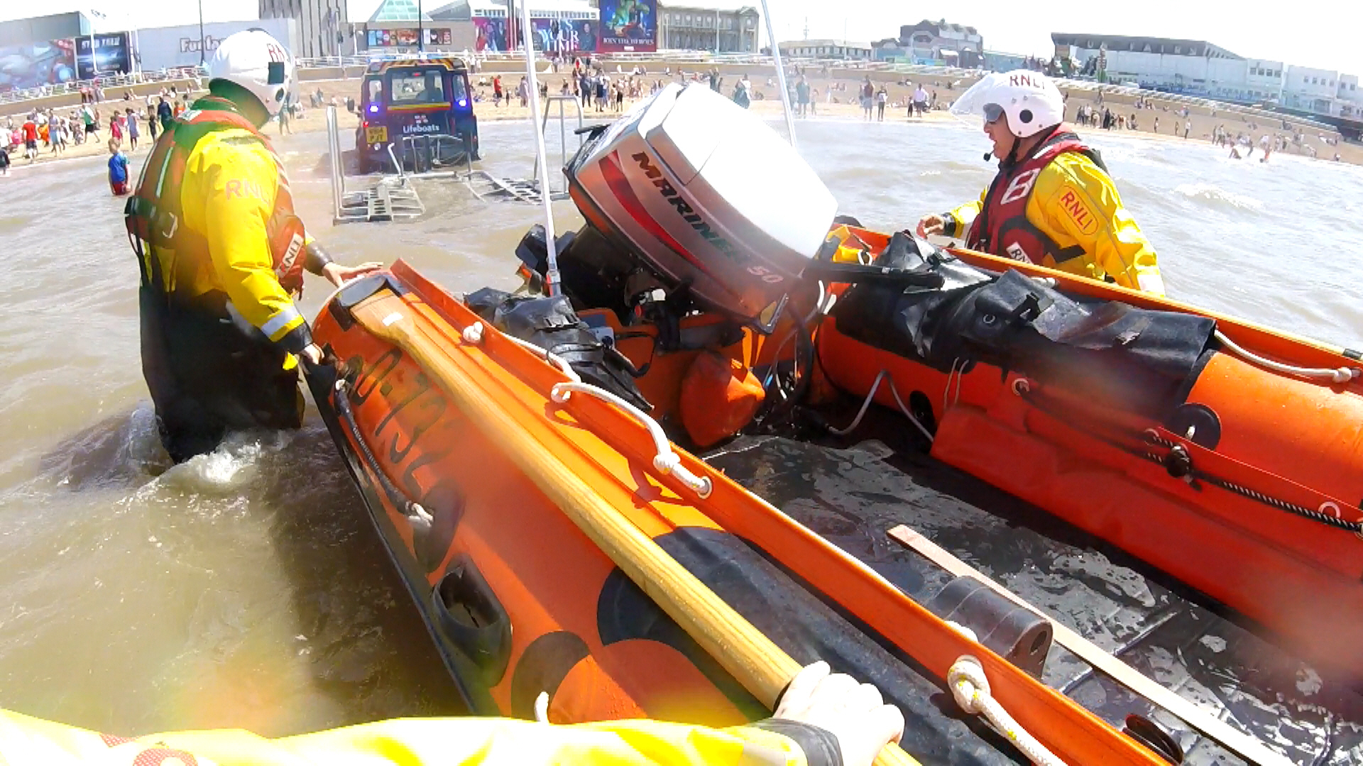Blackpool RNLI volunteers recovering D class onto trailer behind Landrover. 