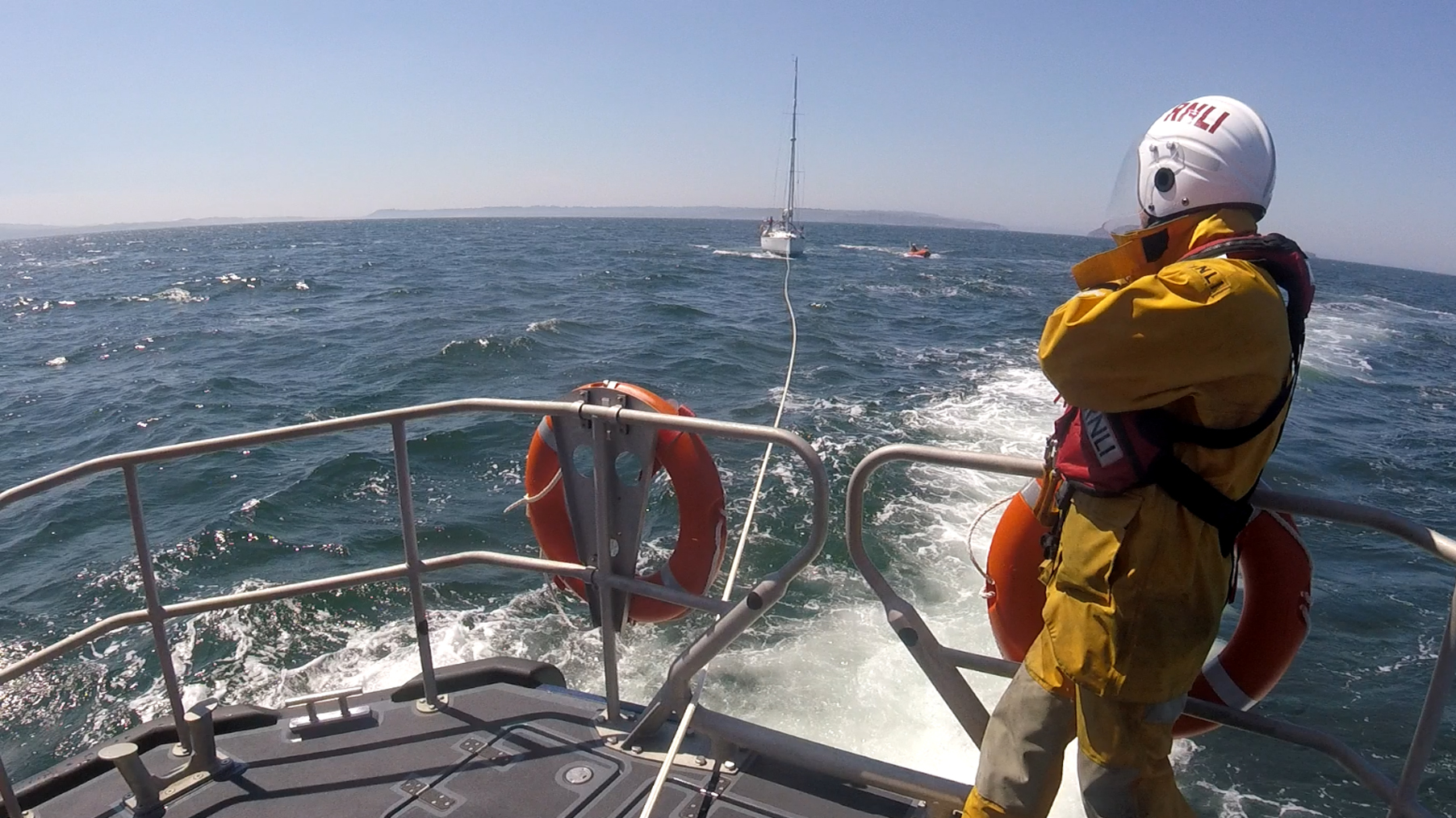 Yacht 'Footsie' under tow.