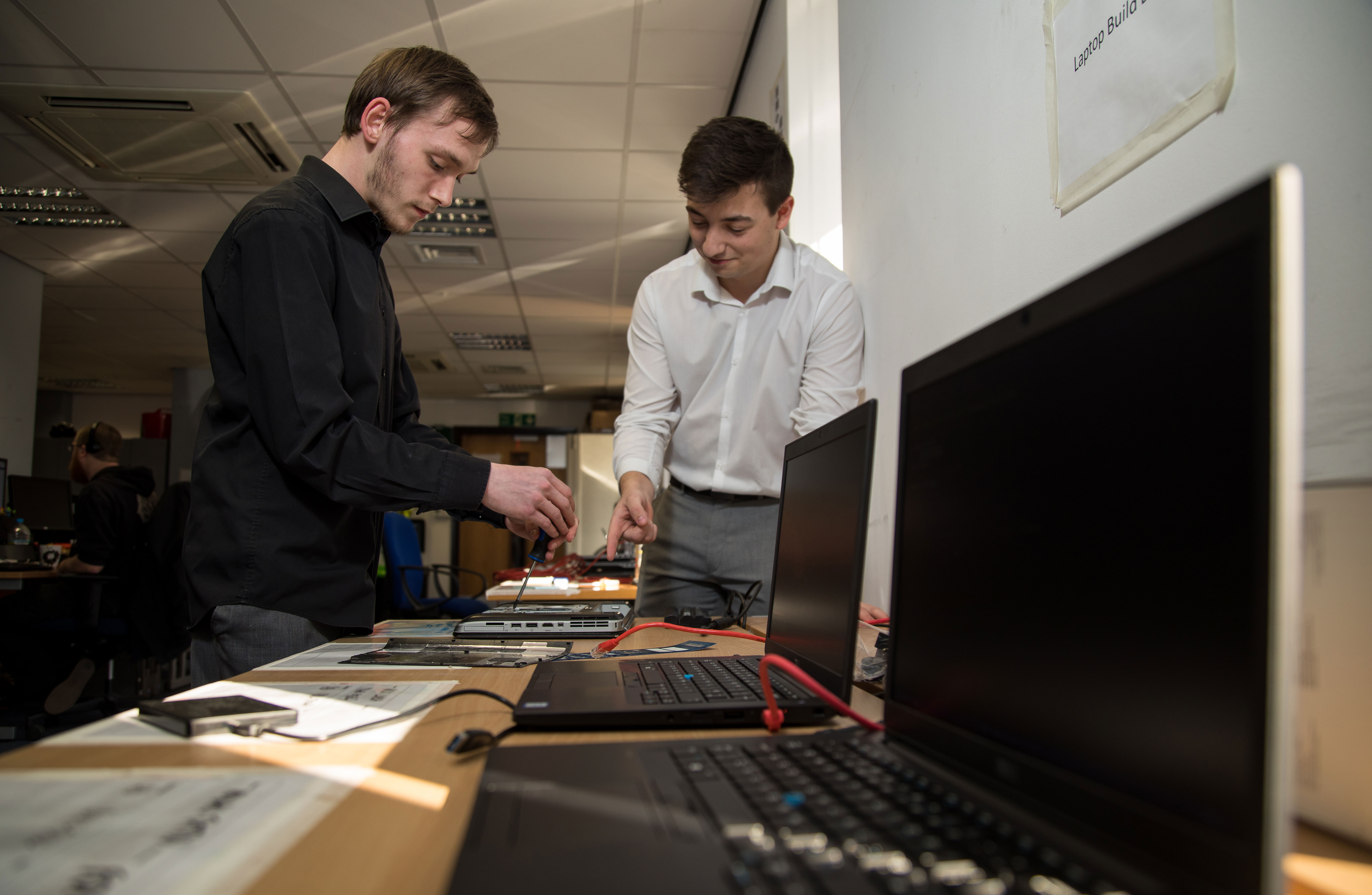 Former RNLI IT apprentice Ashley (right) helps train currently RNLI IT apprentice Joe