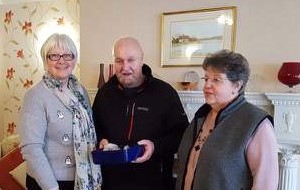 Residents present their donation to Morecambe RNLI volunteer Harry Roberts MBE